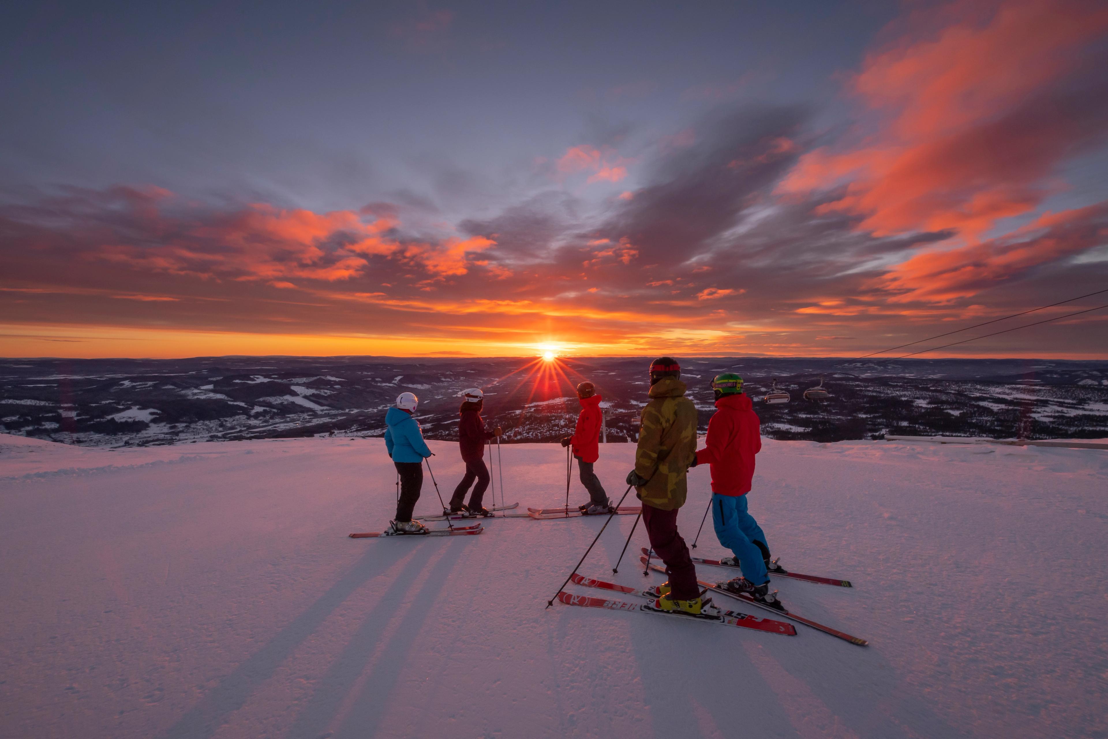 People enjoying the sunset from the slopes at Trysil ski resort in Eastern Norway