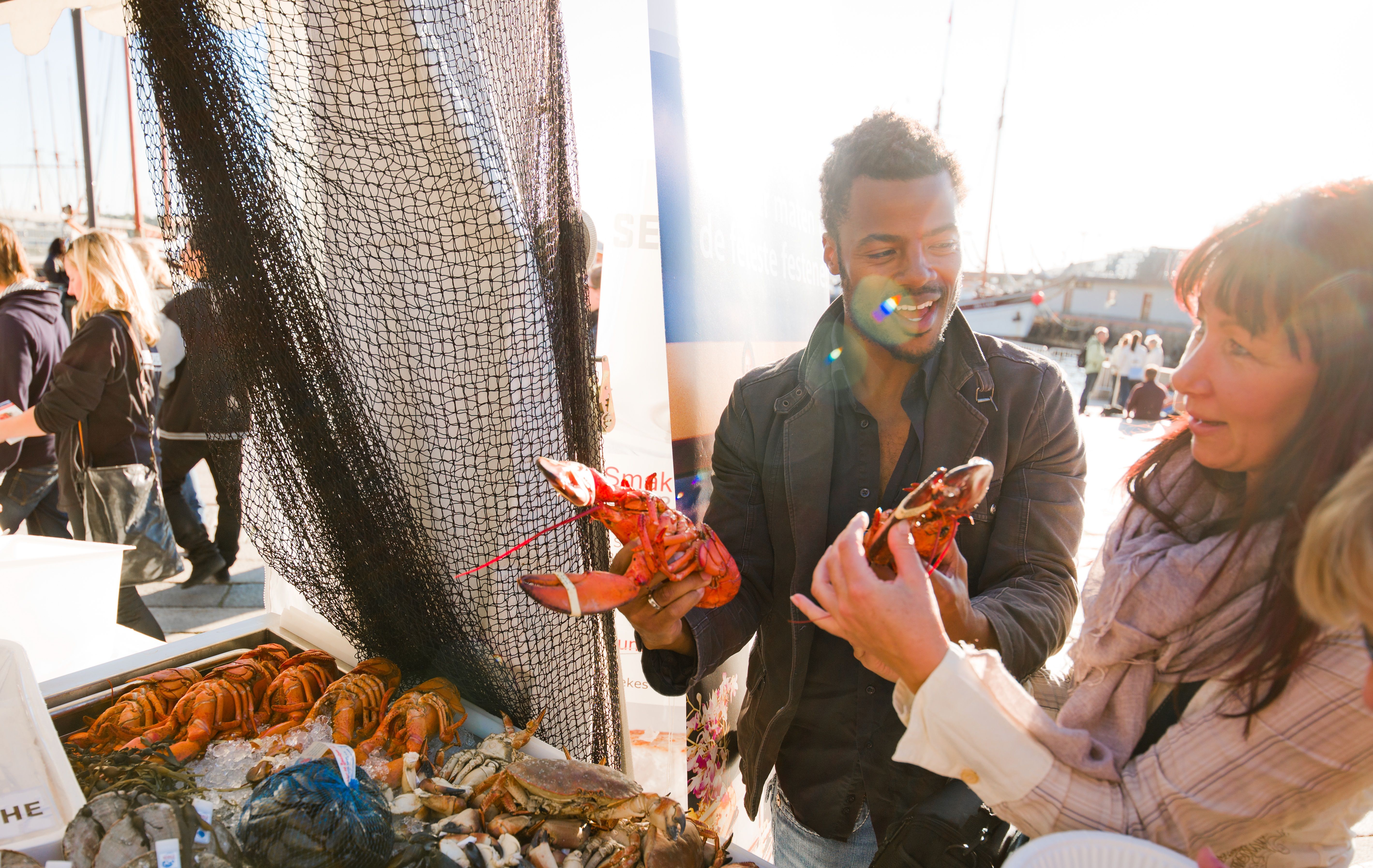 A man and a woman looking at shellfish