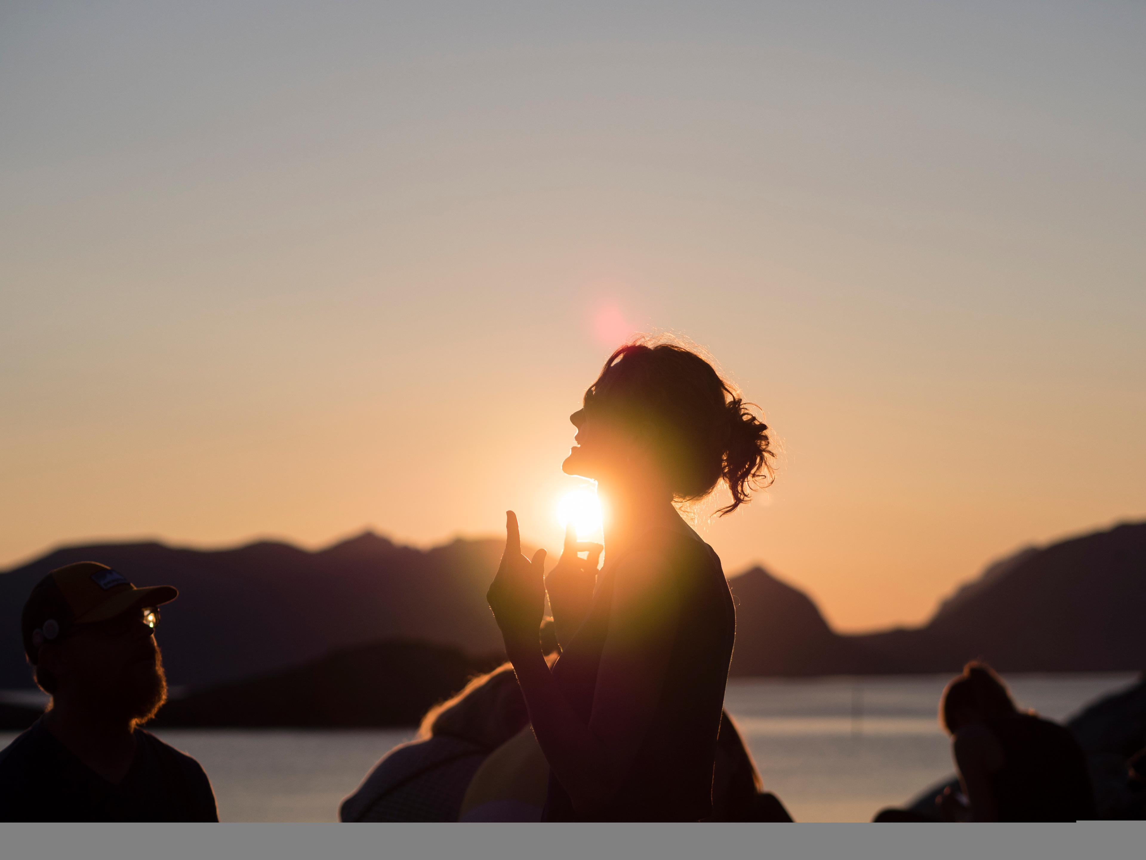 People attending the Trevarefest festival under the midnight sun in Henningsvær, Northern Norway