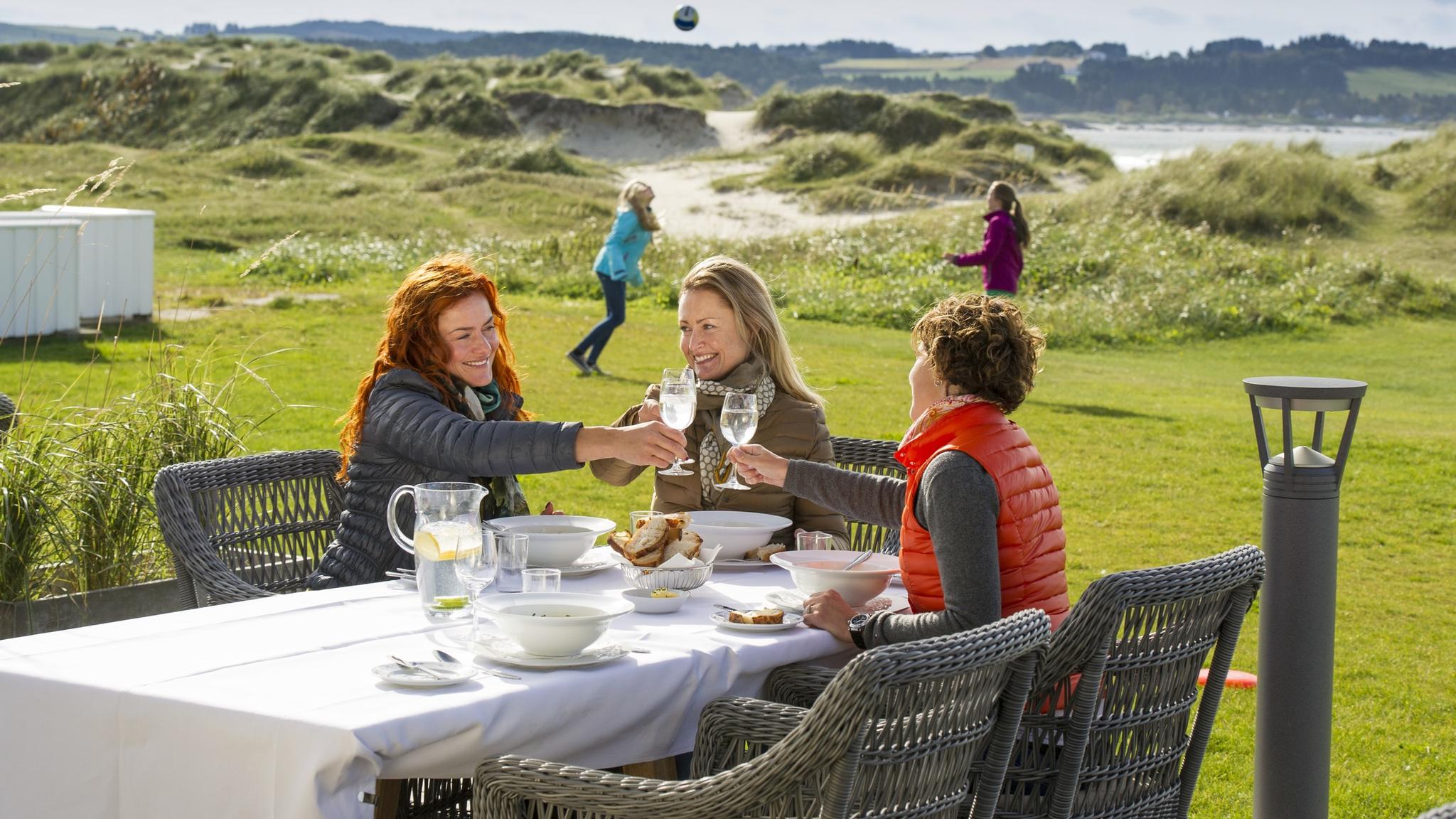 Friends enjoying lunch at Sola Strand Hotel in Jæren, Fjord Norway.