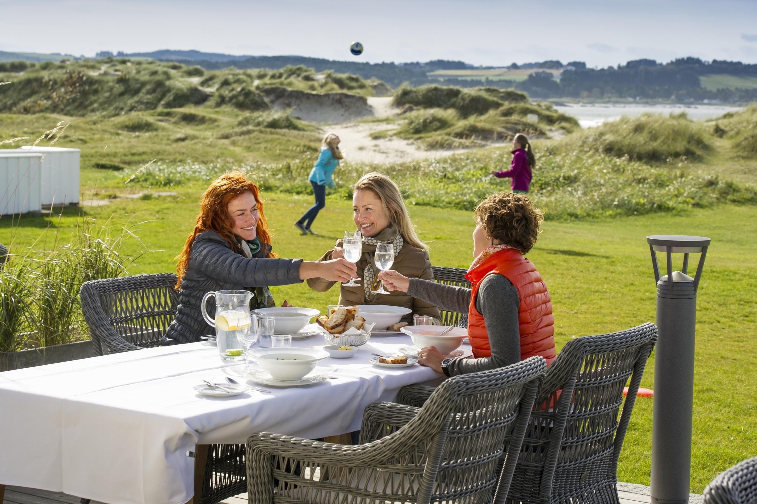 Friends enjoying lunch at Sola Strand Hotel in Jæren, Fjord Norway.