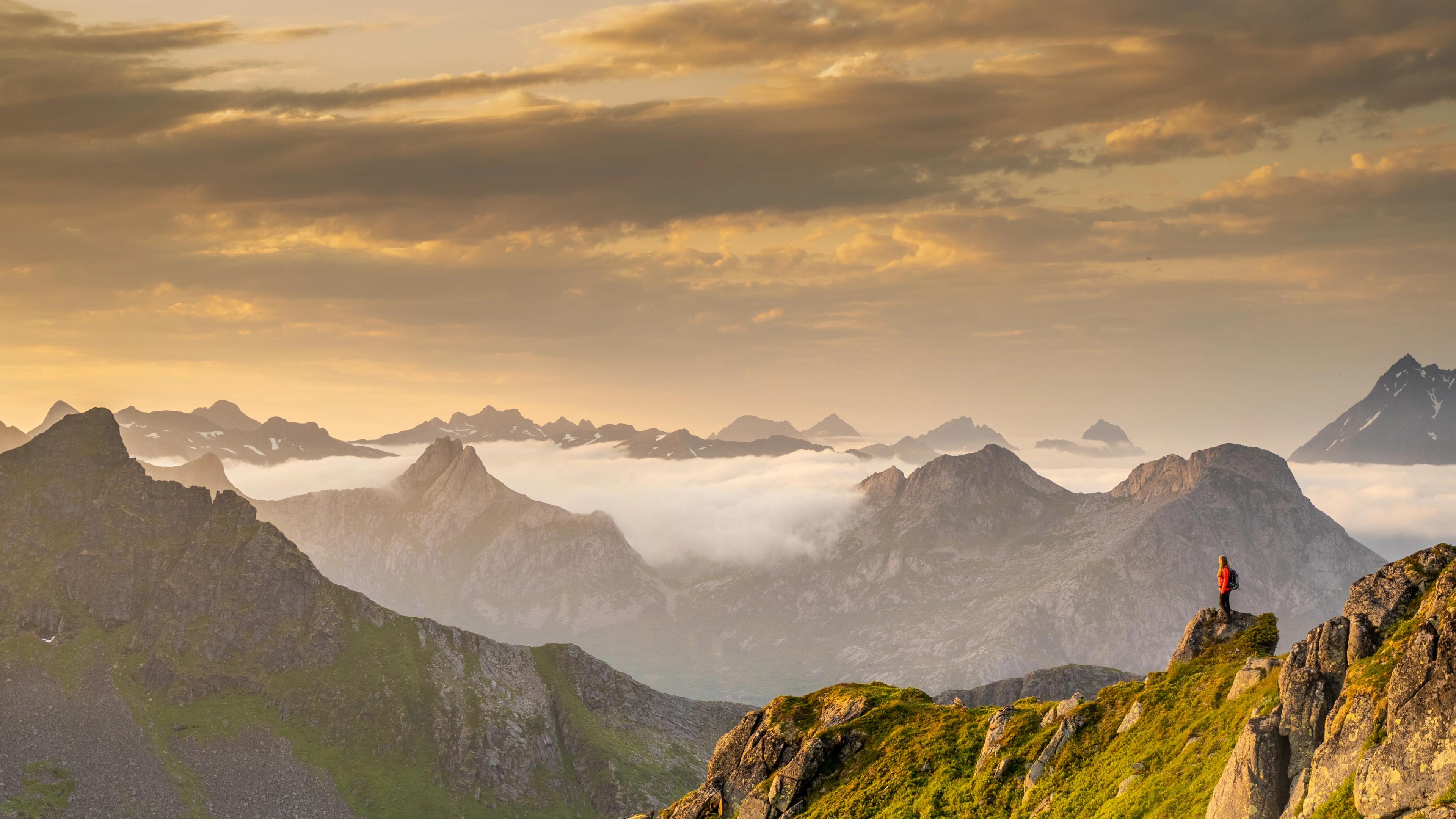 A woman hiking in the immense mountains in Svolvær, Northern Norway