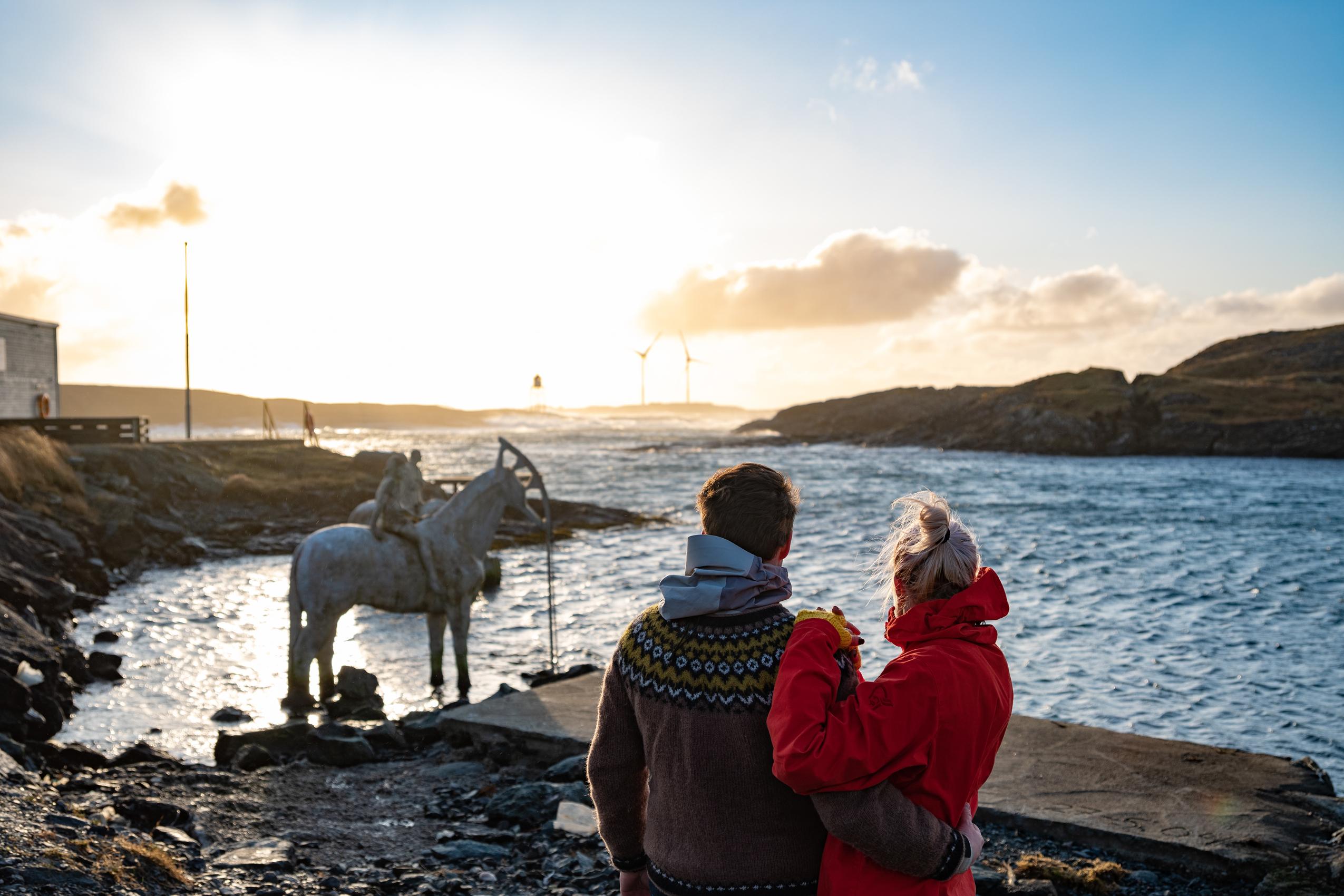 Two people watching the rising tide, in Haugesund