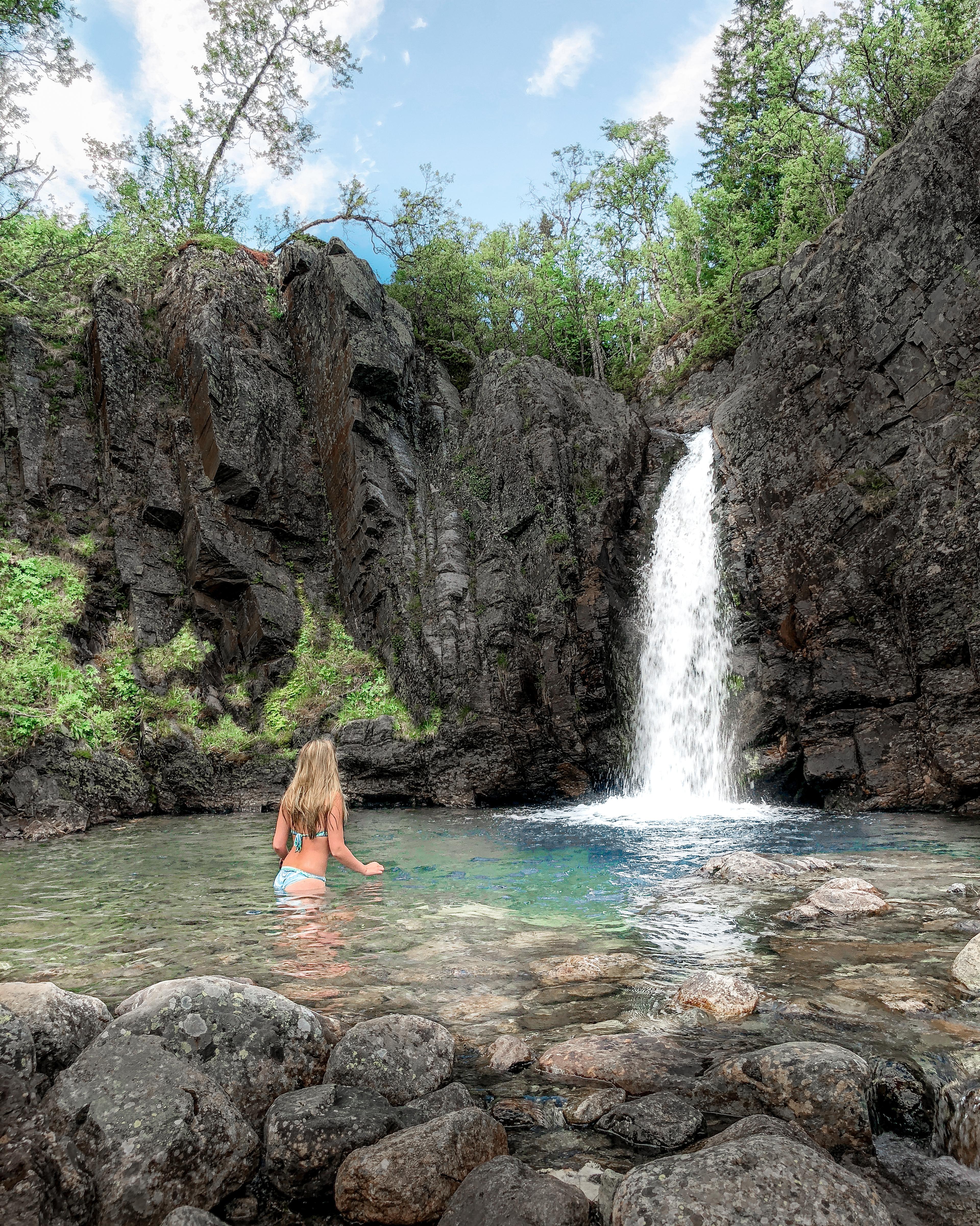 A woman bathing under a waterfall in Hemsedal, Eastern Norway