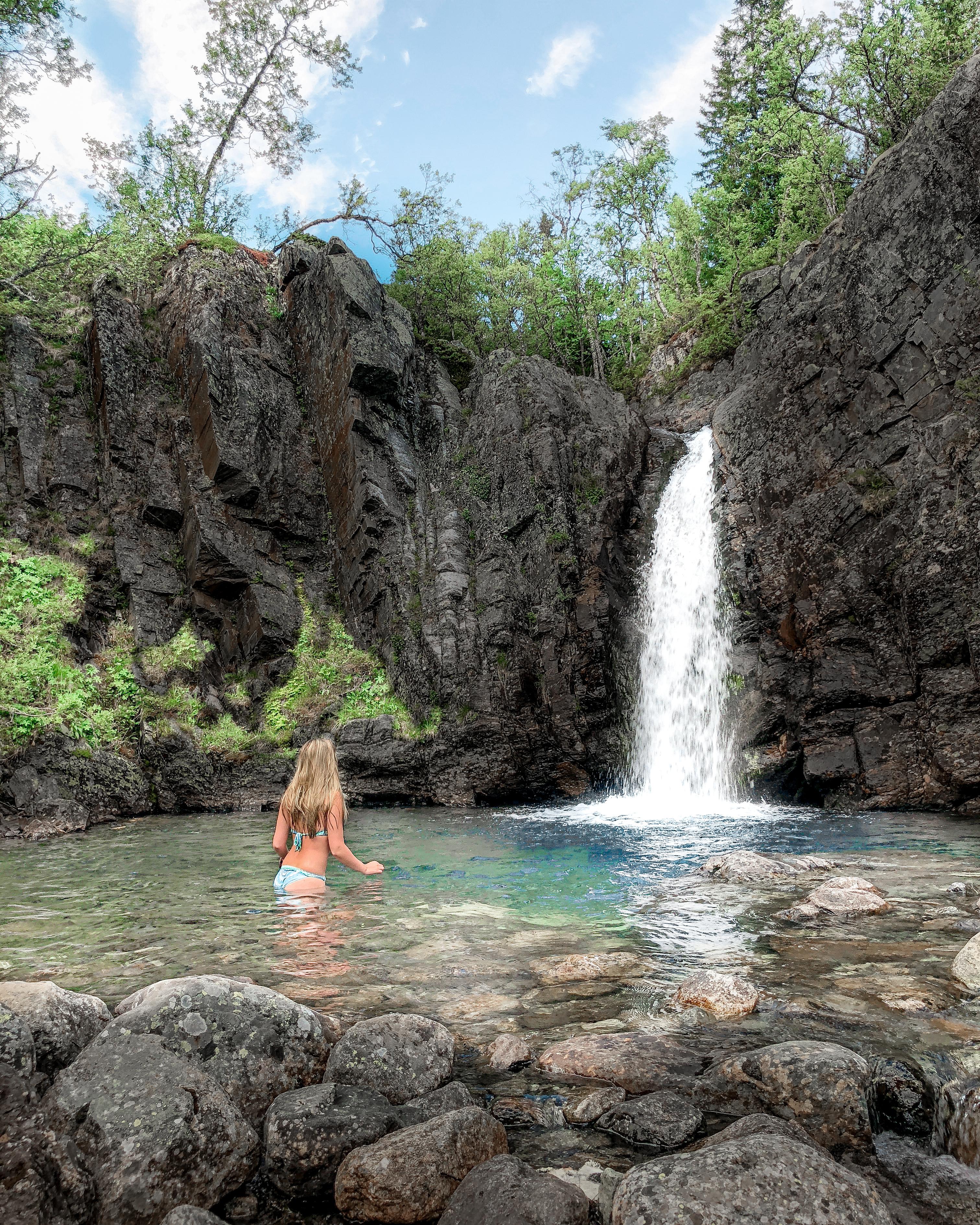 A woman bathing under a waterfall in Hemsedal, Eastern Norway