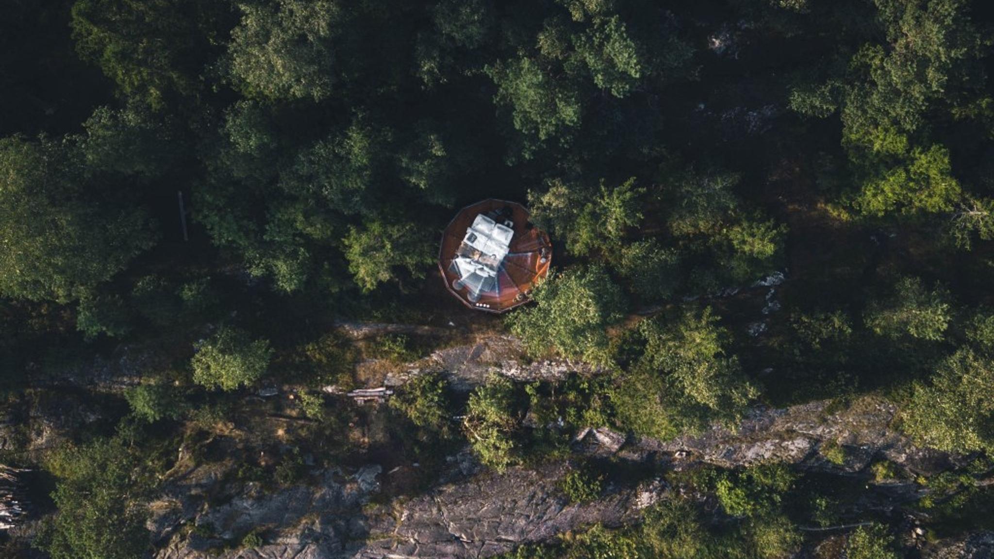 A birdseye view of a clear igloo in the forest