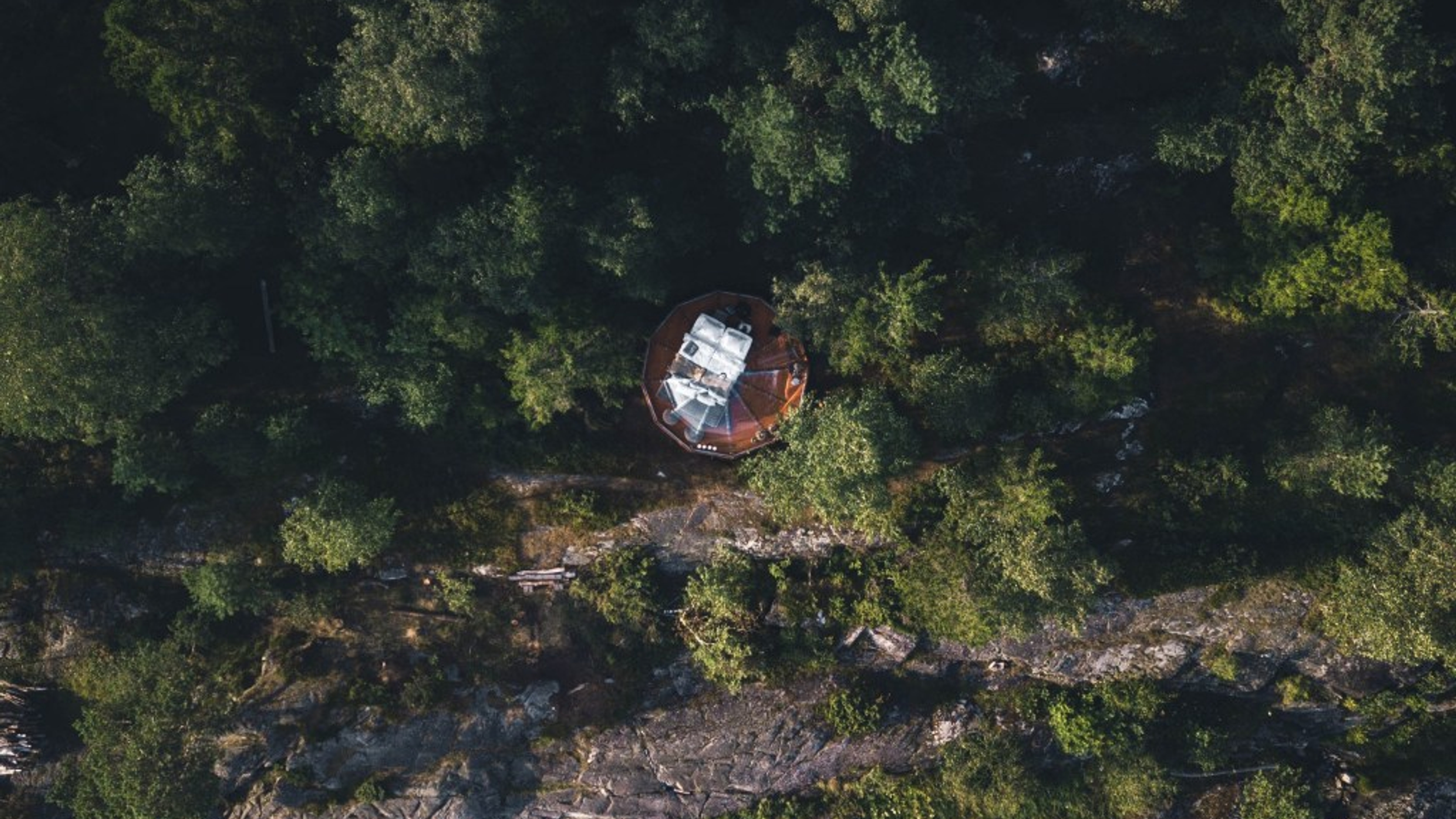 A birdseye view of a clear igloo in the forest