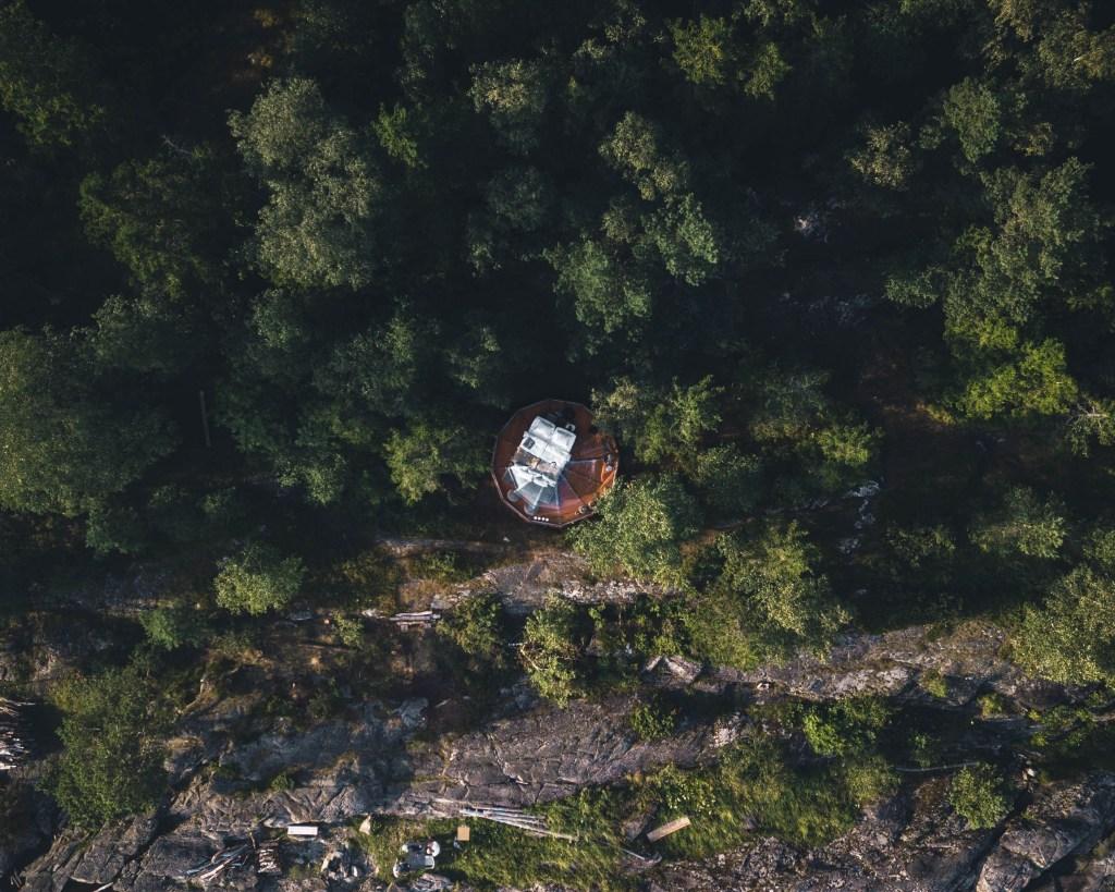 A birdseye view of a clear igloo in the forest