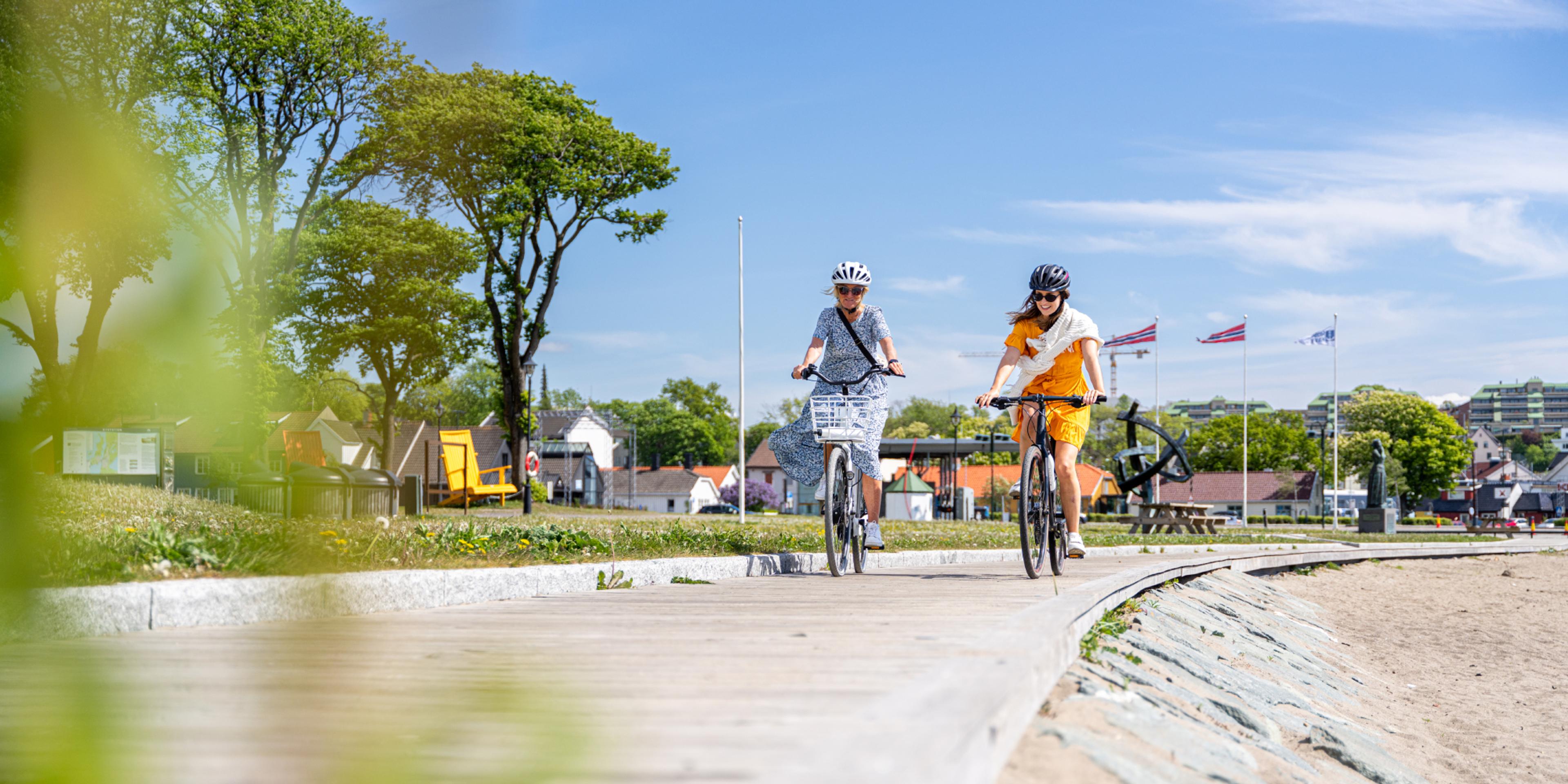 Two women biking along the beach in Moss, Østfold