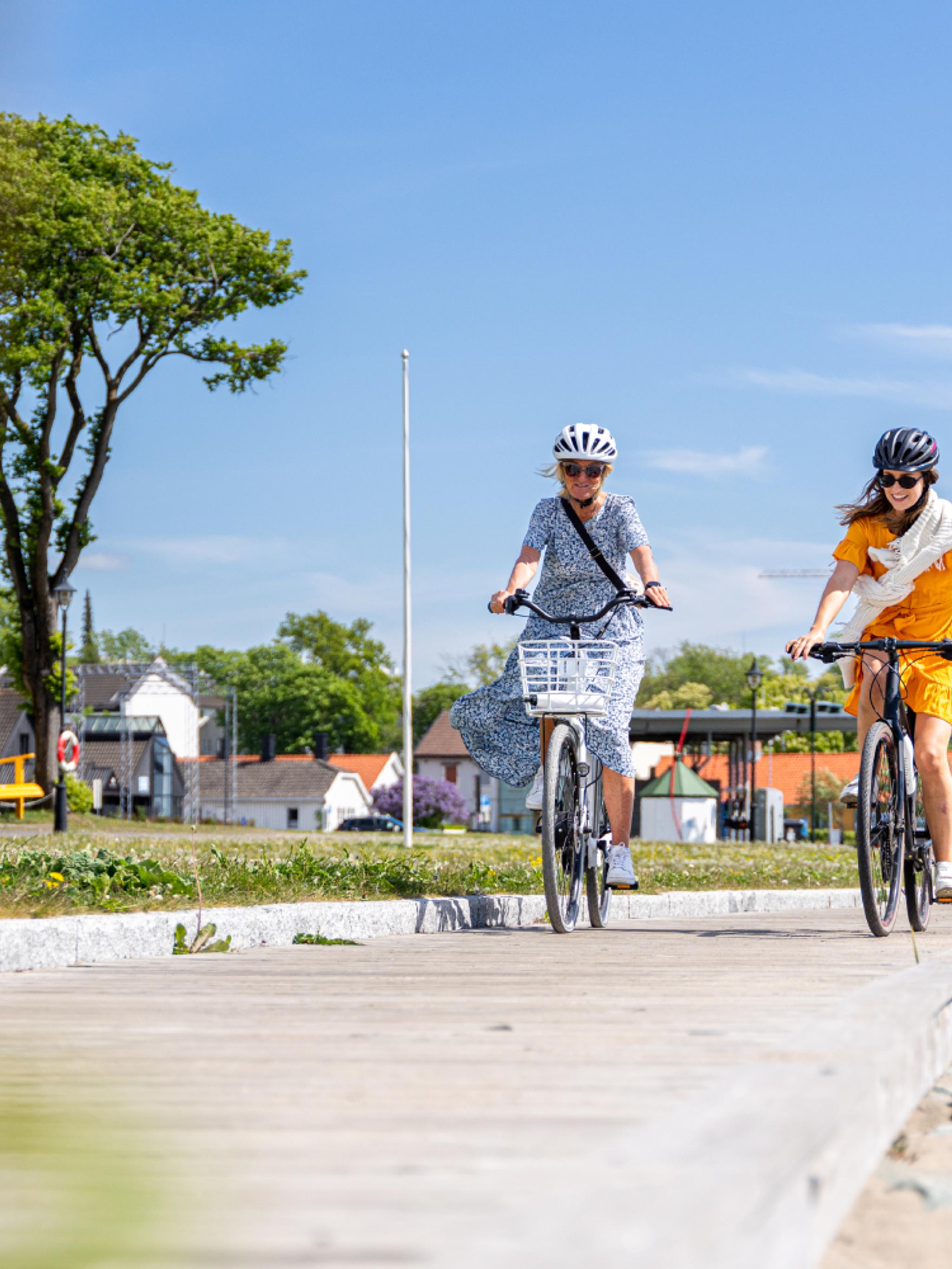 Two women biking along the beach in Moss, Østfold