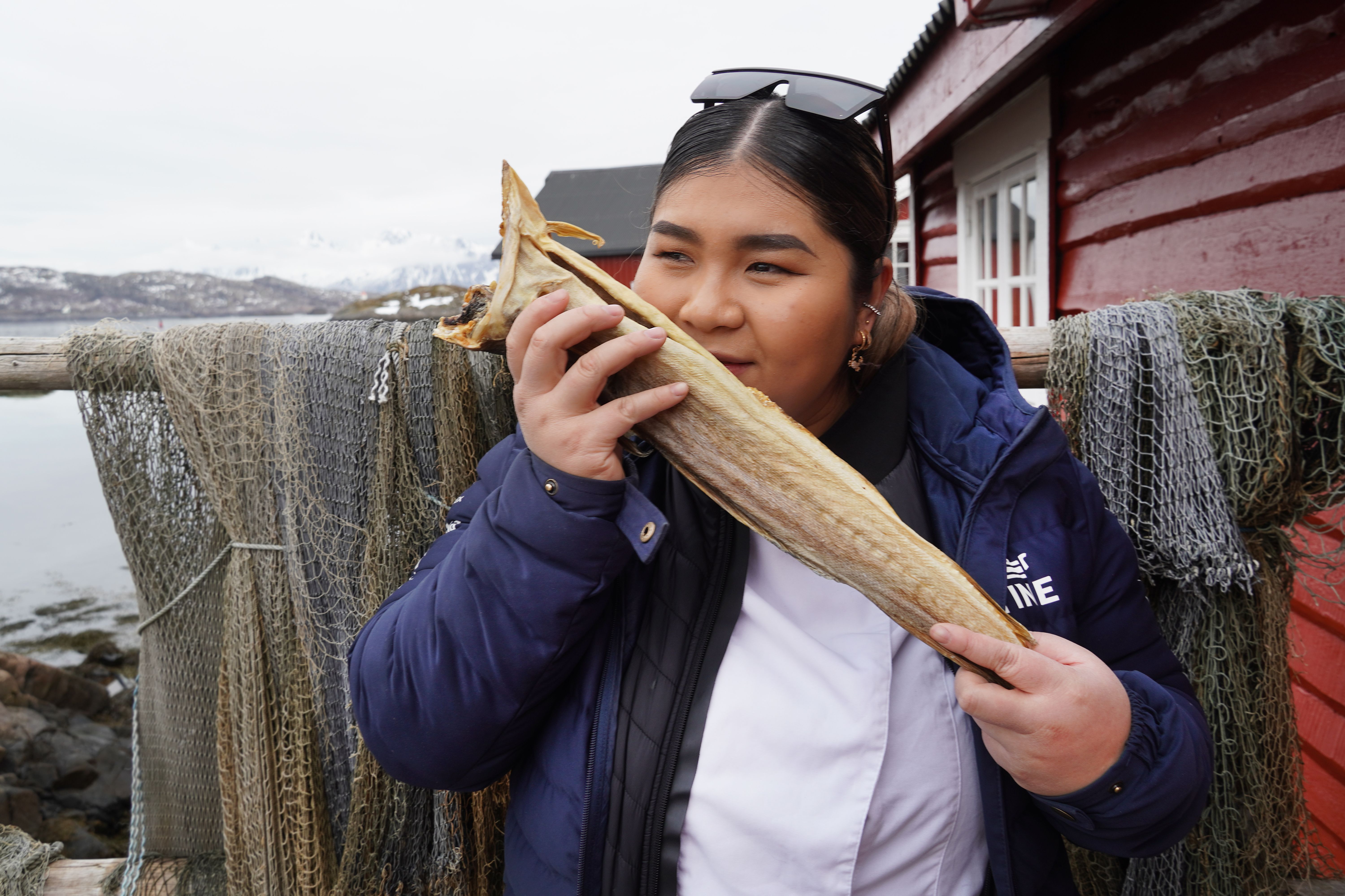 Asian looking woman smelling stockfish