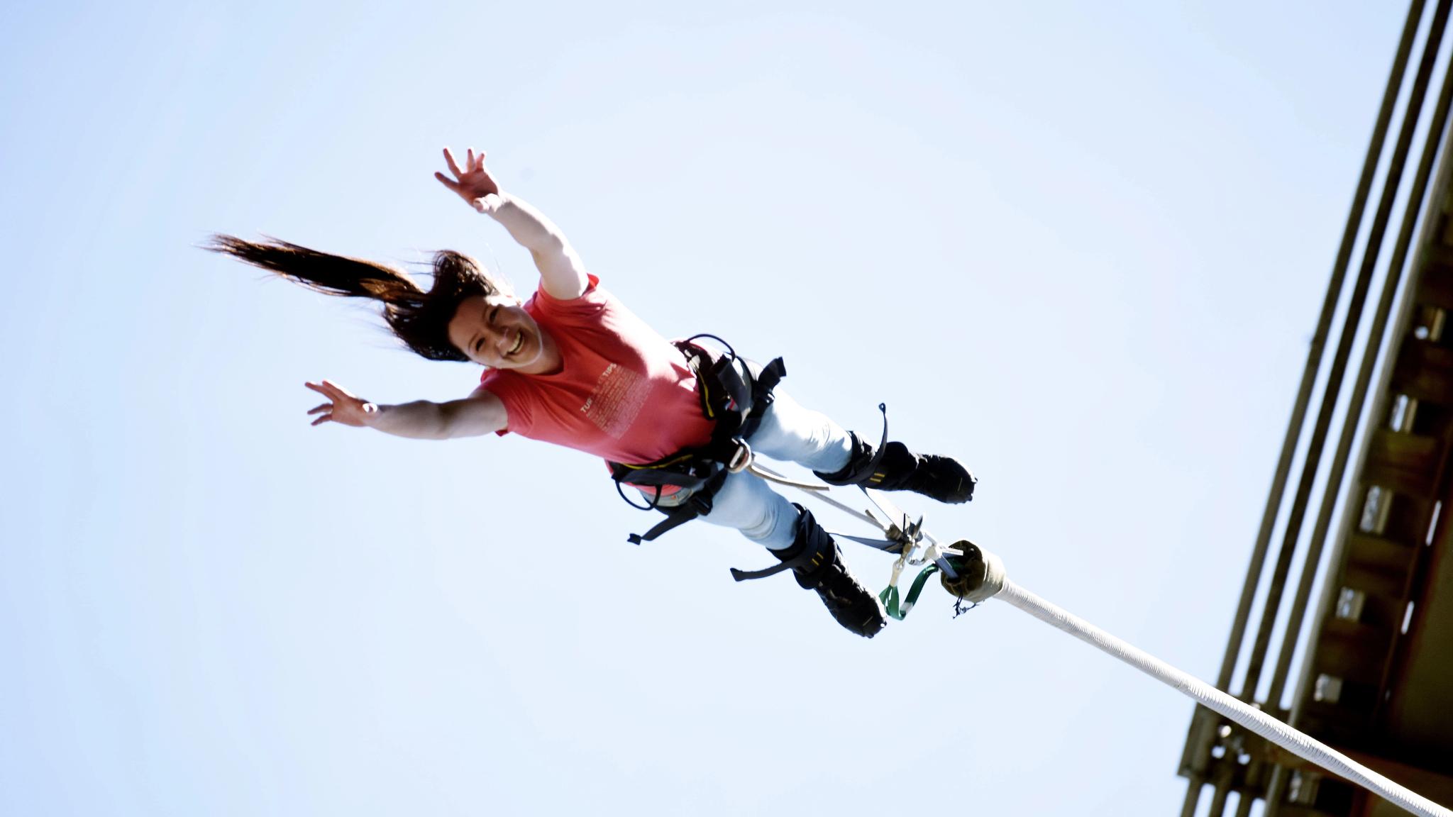A woman bungee jumping off a bridge in Rjukan in Telemark, Eastern Norway