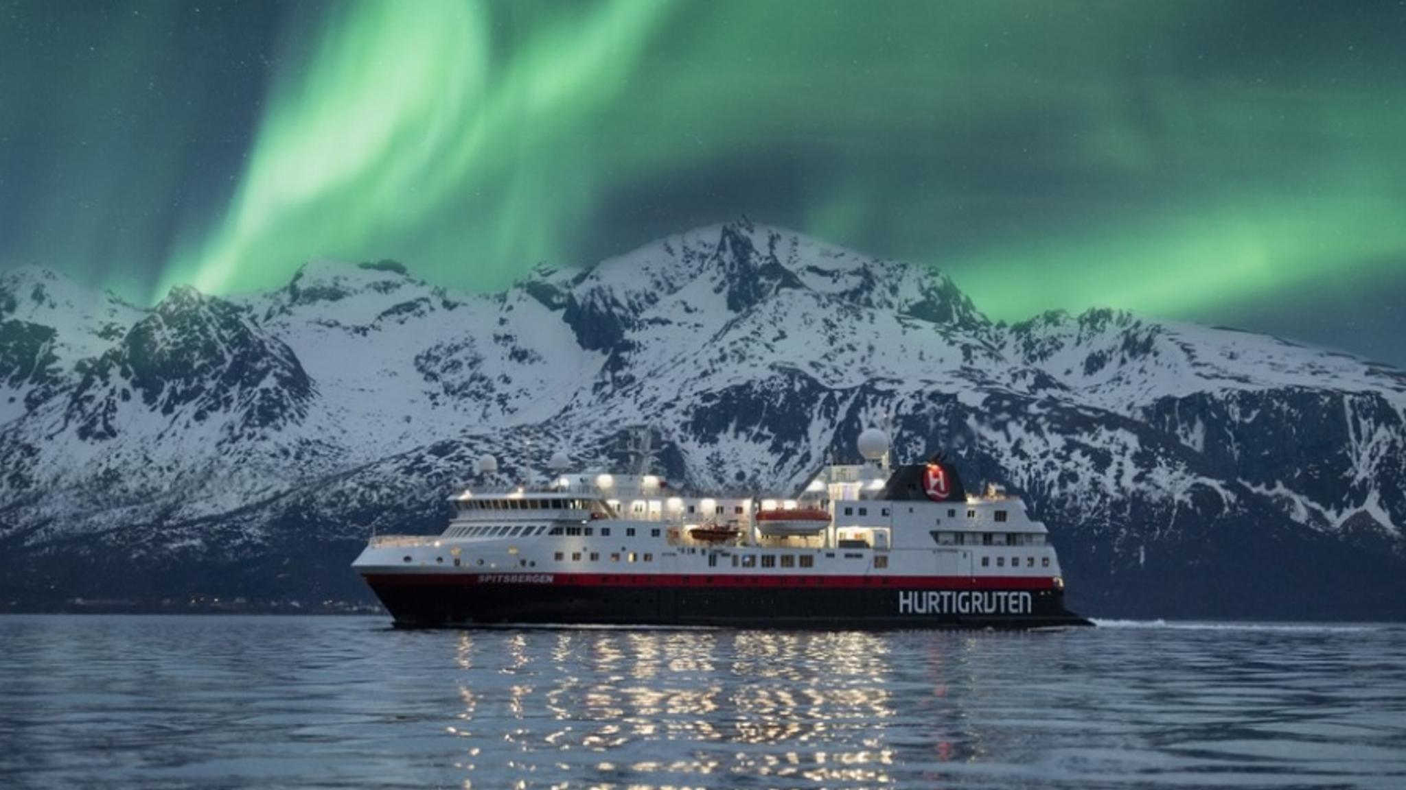Hurtigruten sailing under the northern lights at wintertime