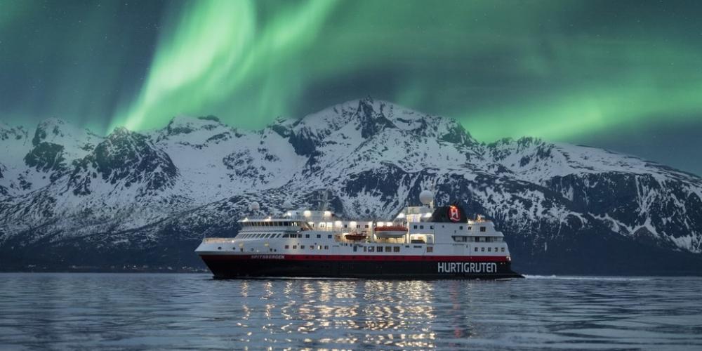 Hurtigruten sailing under the northern lights at wintertime