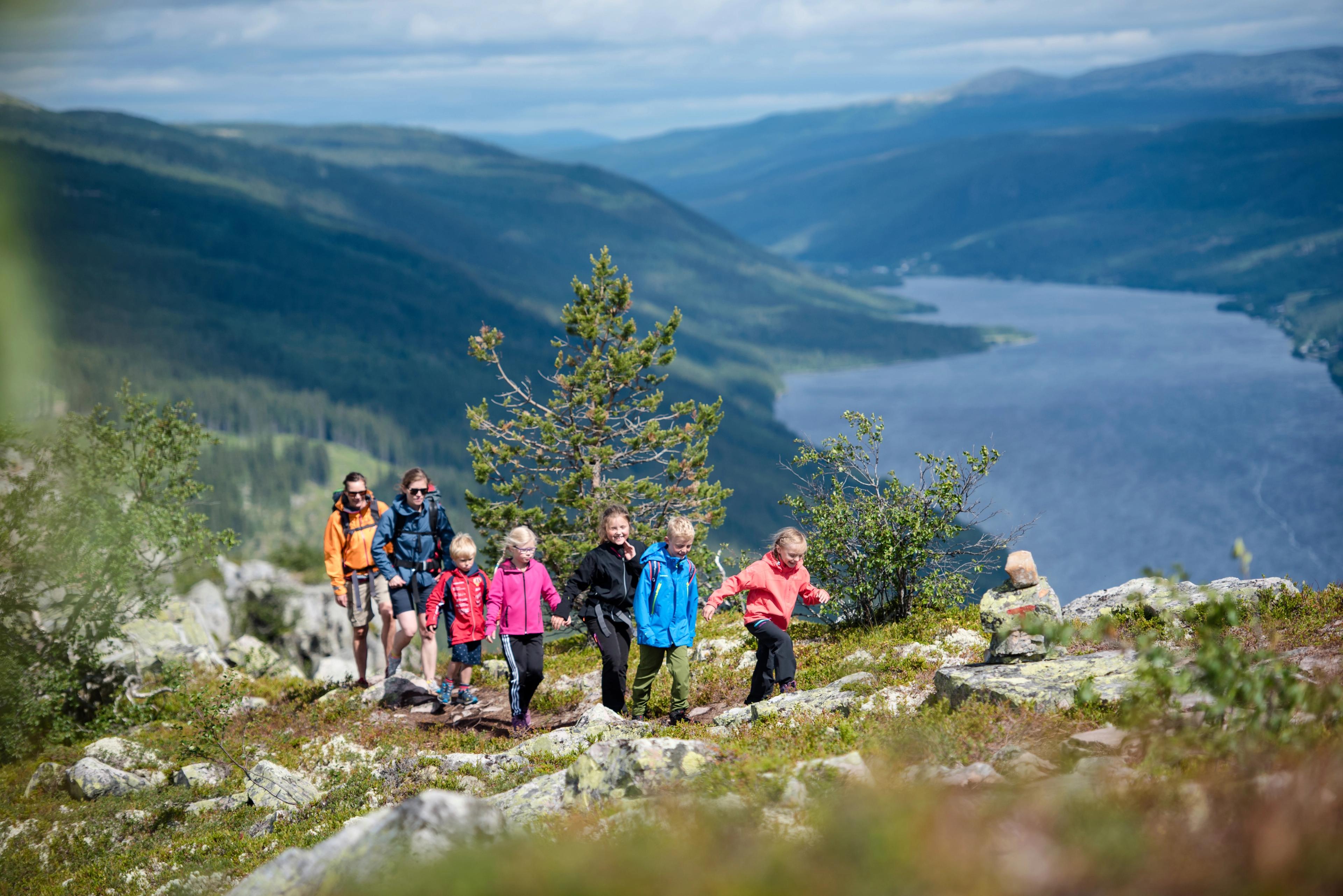 A family is hiking the round trip to mount Skagsvola in Trysil, Eastern Norway