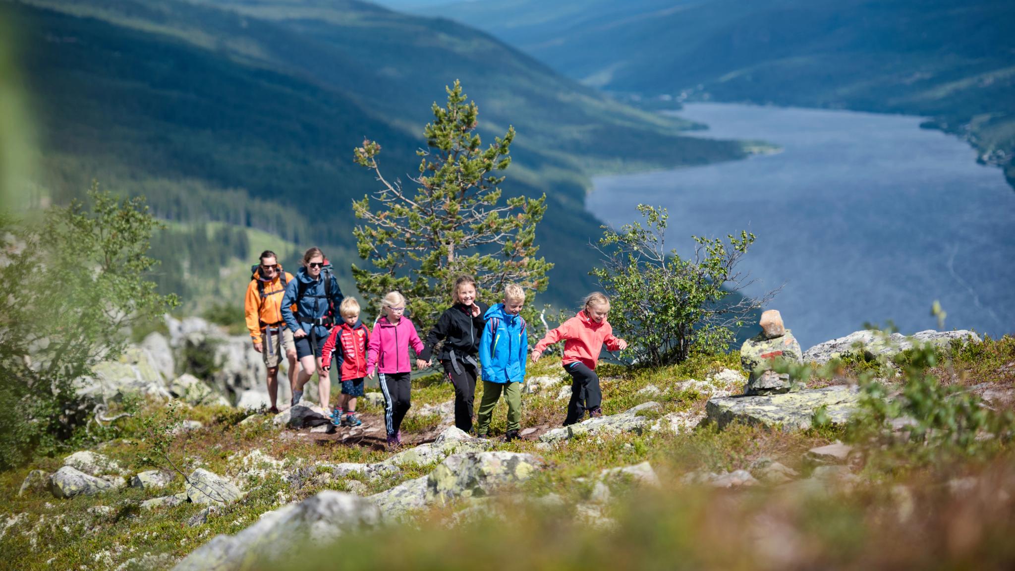 A family is hiking the round trip to mount Skagsvola in Trysil, Eastern Norway