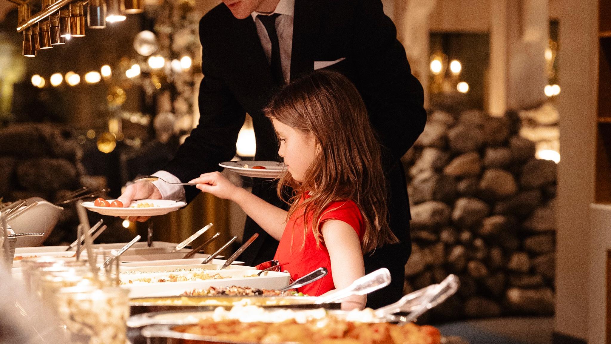 A girl at a dinner buffet at Hotel Alexandra in Loen
