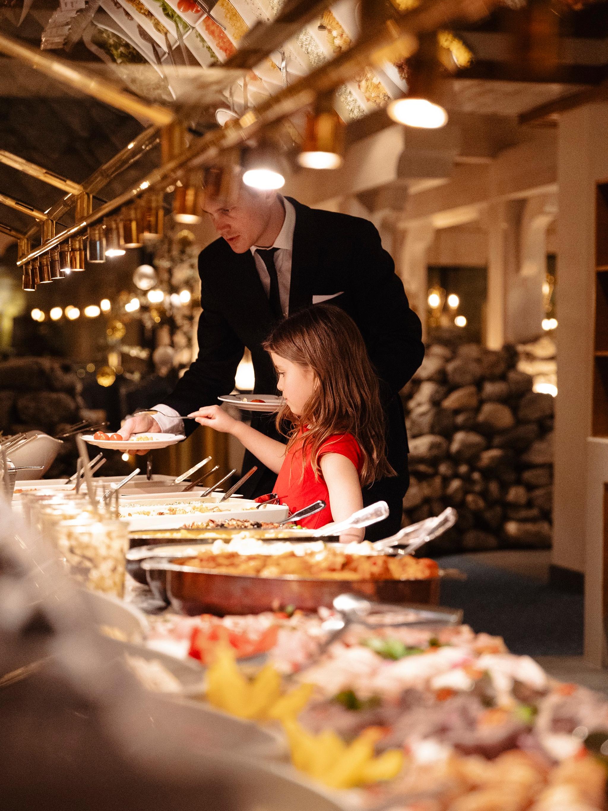 A girl at a dinner buffet at Hotel Alexandra in Loen