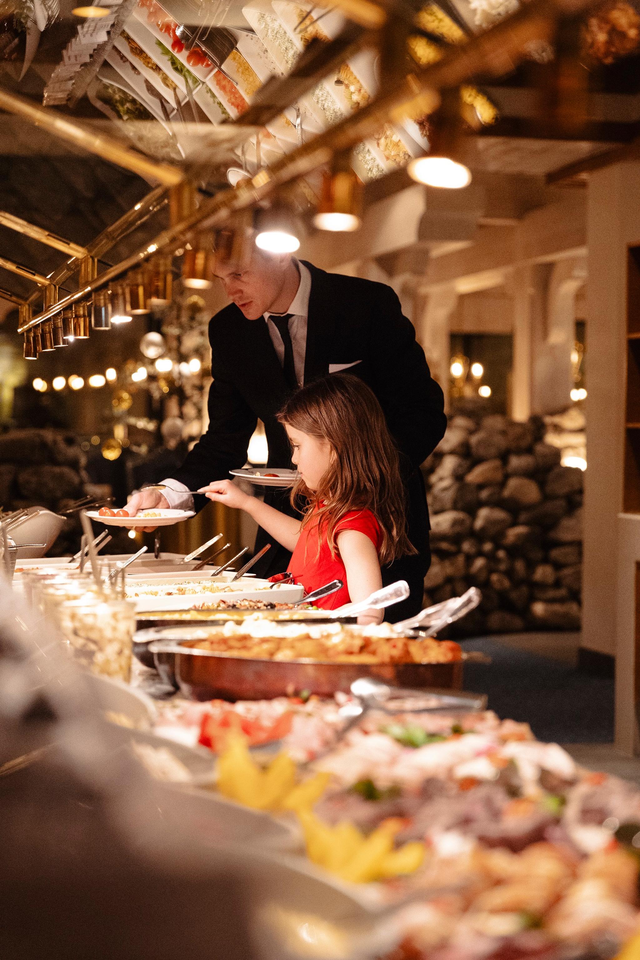 A girl at a dinner buffet at Hotel Alexandra in Loen