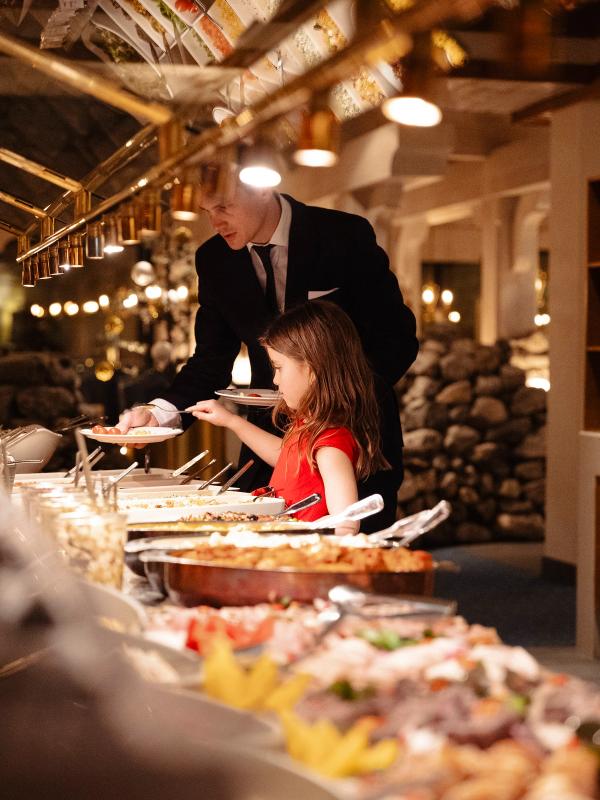 A girl at a dinner buffet at Hotel Alexandra in Loen