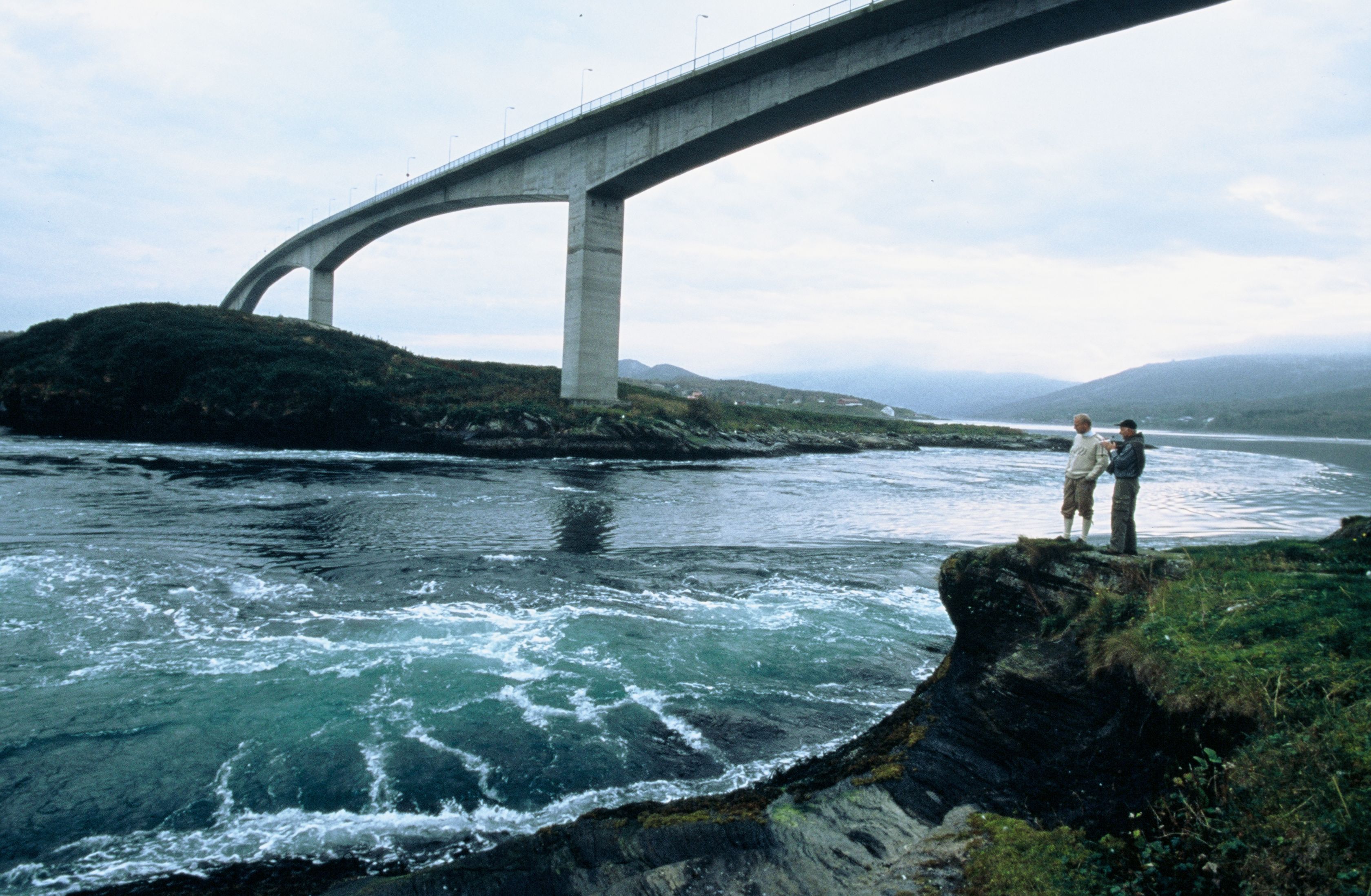 People standing at a Saltstraumen view point along the shore line, in Northern Norway.