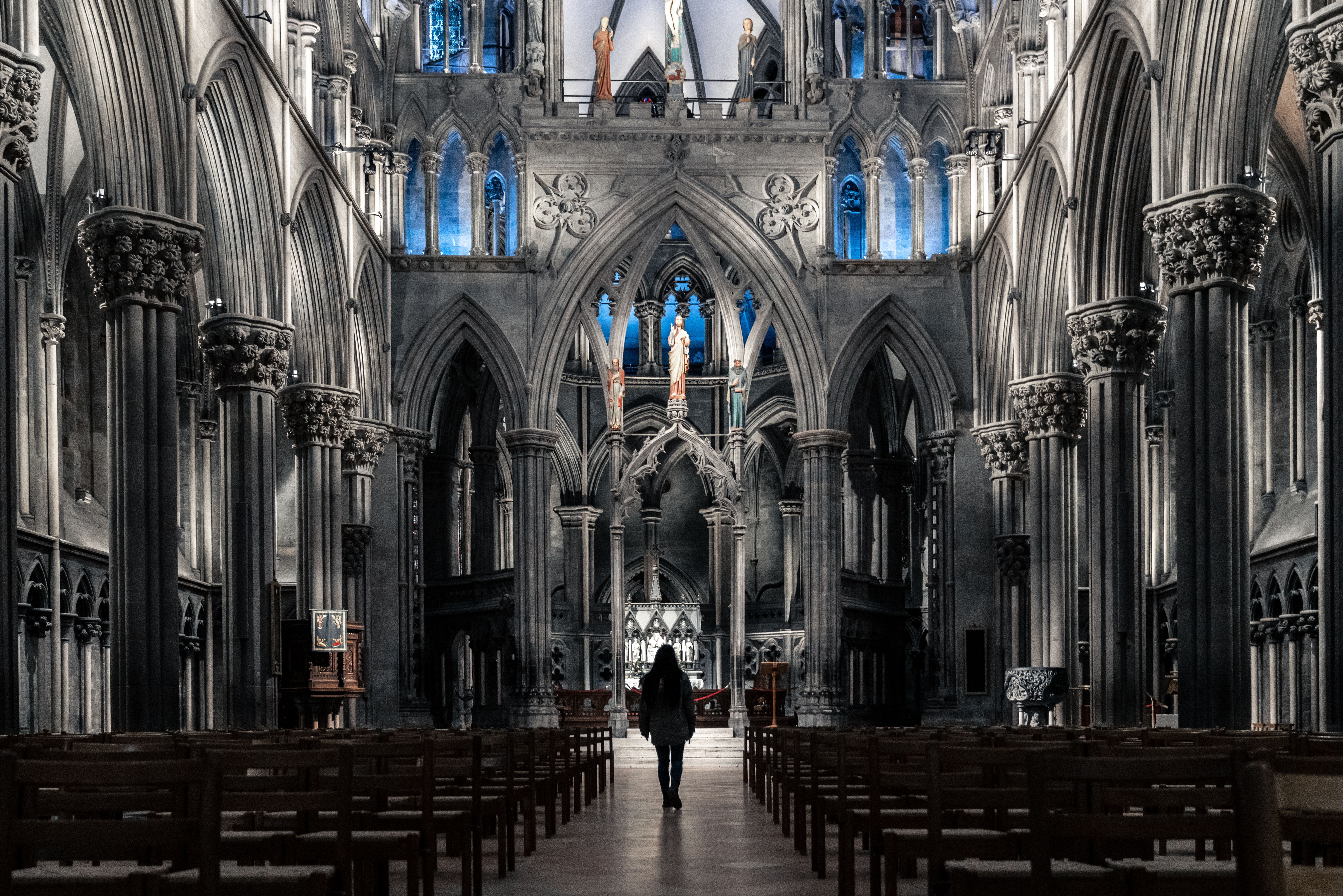A woman standing in the spectacular Nidarosdomen, Nidarosdomen, Nidaros Cathedral, in Trondheim