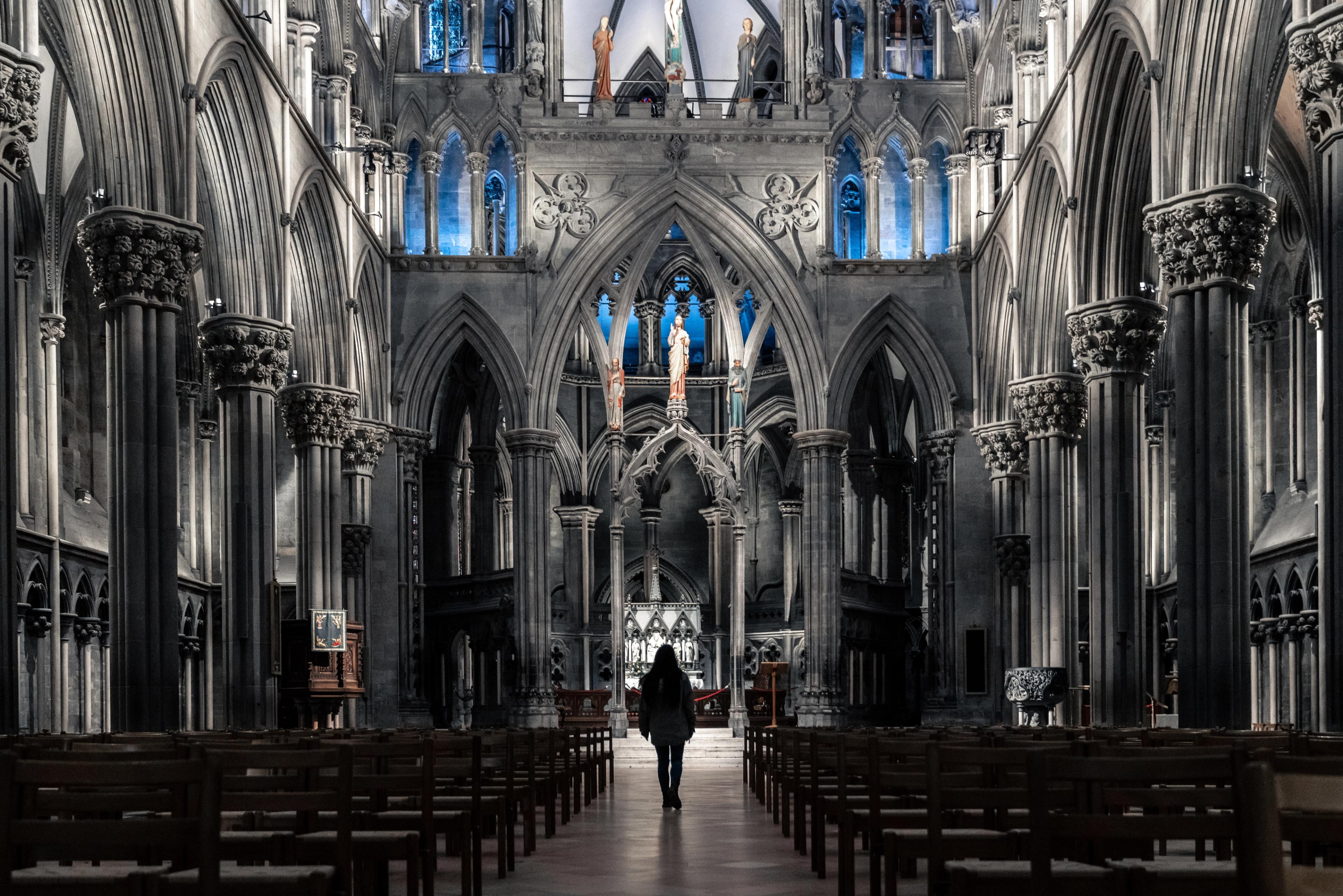 A woman standing in the spectacular Nidarosdomen, Nidarosdomen, Nidaros Cathedral, in Trondheim