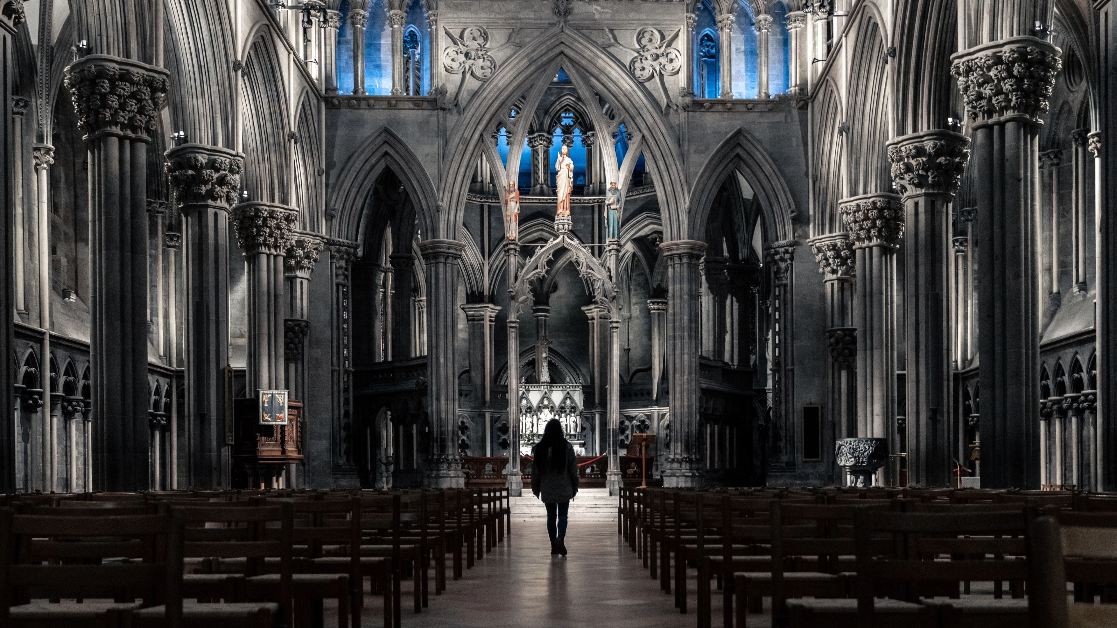A woman standing in the spectacular Nidarosdomen, Nidarosdomen, Nidaros Cathedral, in Trondheim