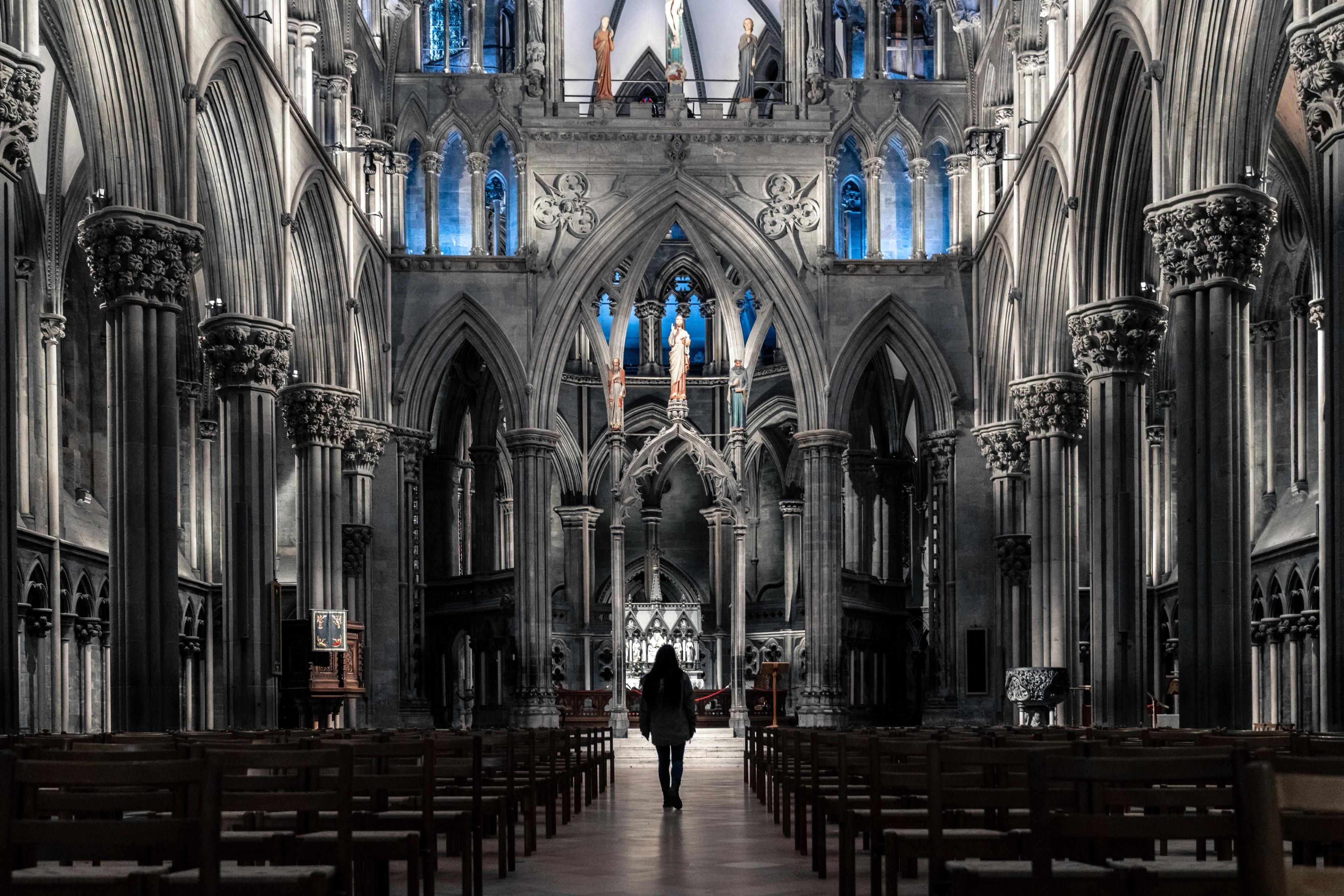 A woman standing in the spectacular Nidarosdomen, Nidarosdomen, Nidaros Cathedral, in Trondheim