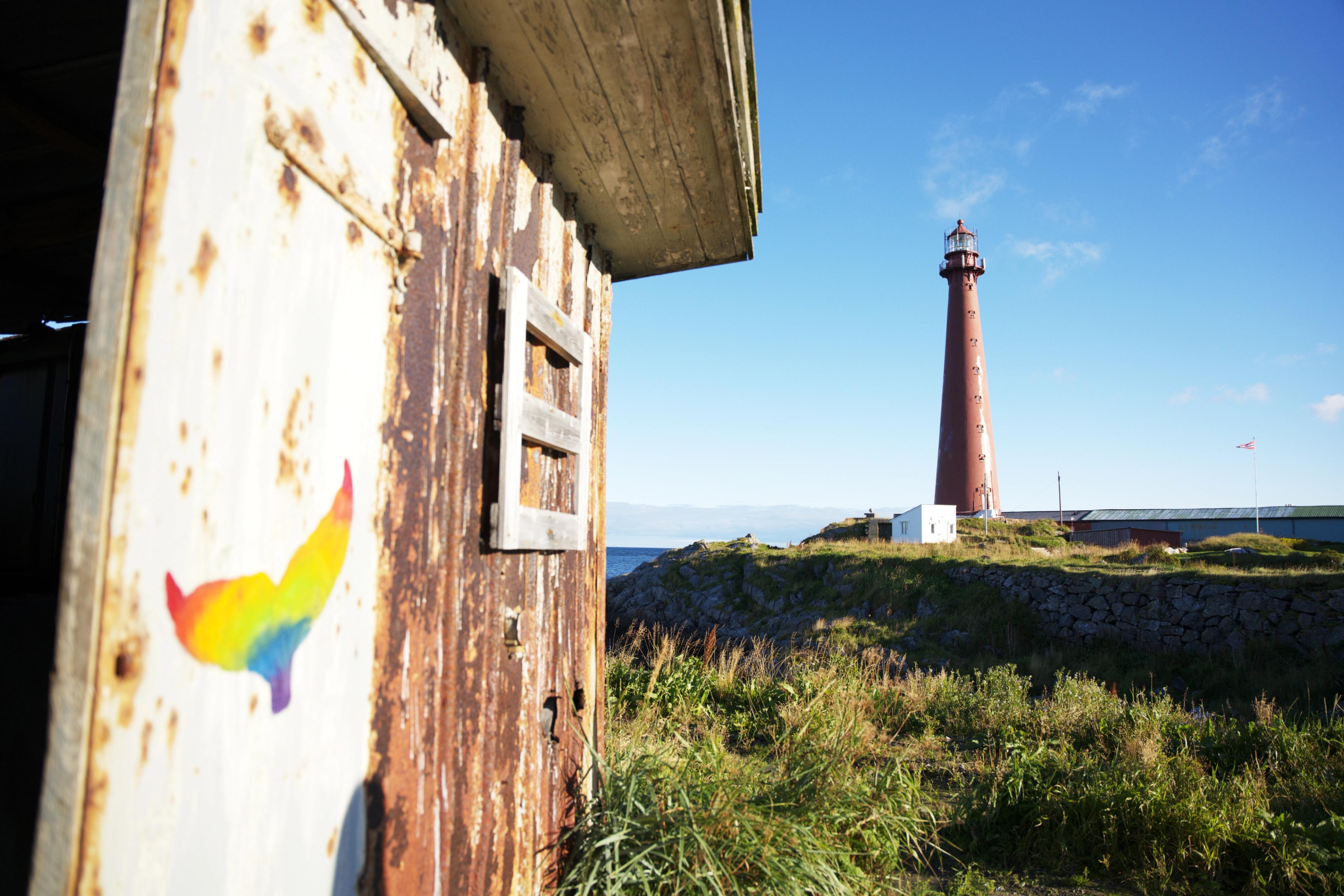 Wall art of a whale with Andenes lighthouse in the backround