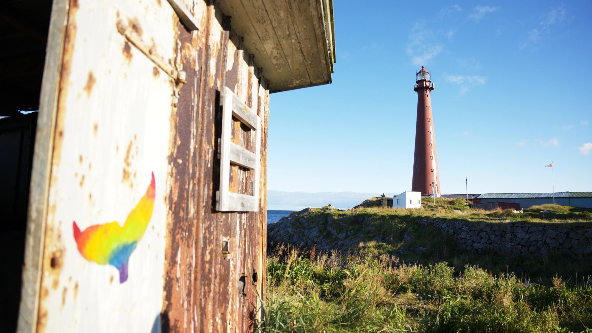 Wall art of a whale with Andenes lighthouse in the backround