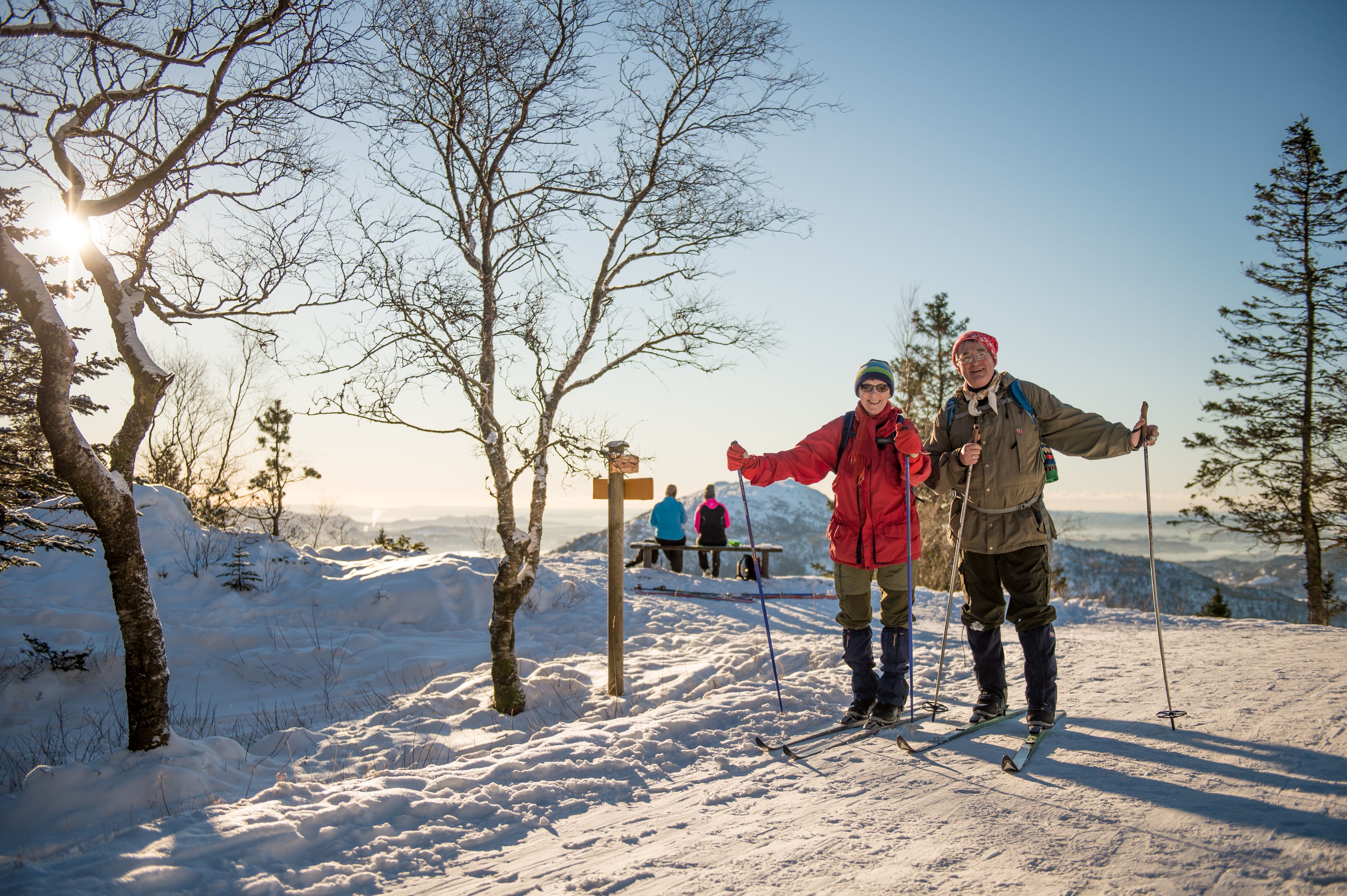 Elderly couple cross-country skiing at Mount Fløyen in Bergen, Fjord Norway