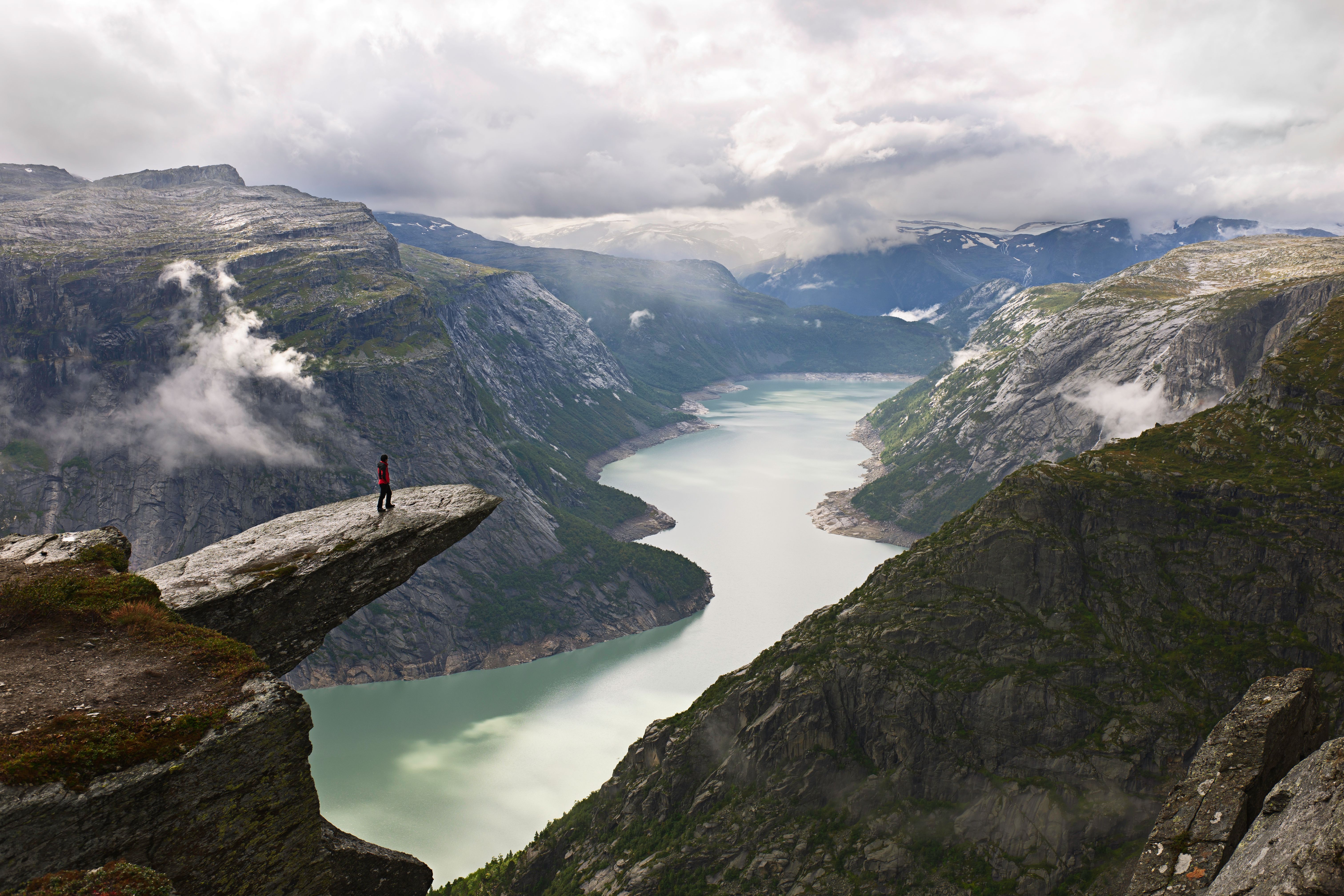 A person on the mountain plateau Trolltunga above Lake Ringedalsvatnet in the Hardangerfjord region, Fjord Norway
