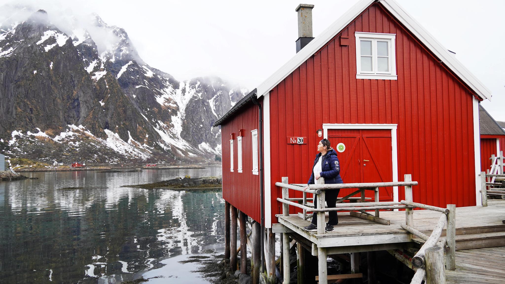 A woman in front of a fisherman´s cabin