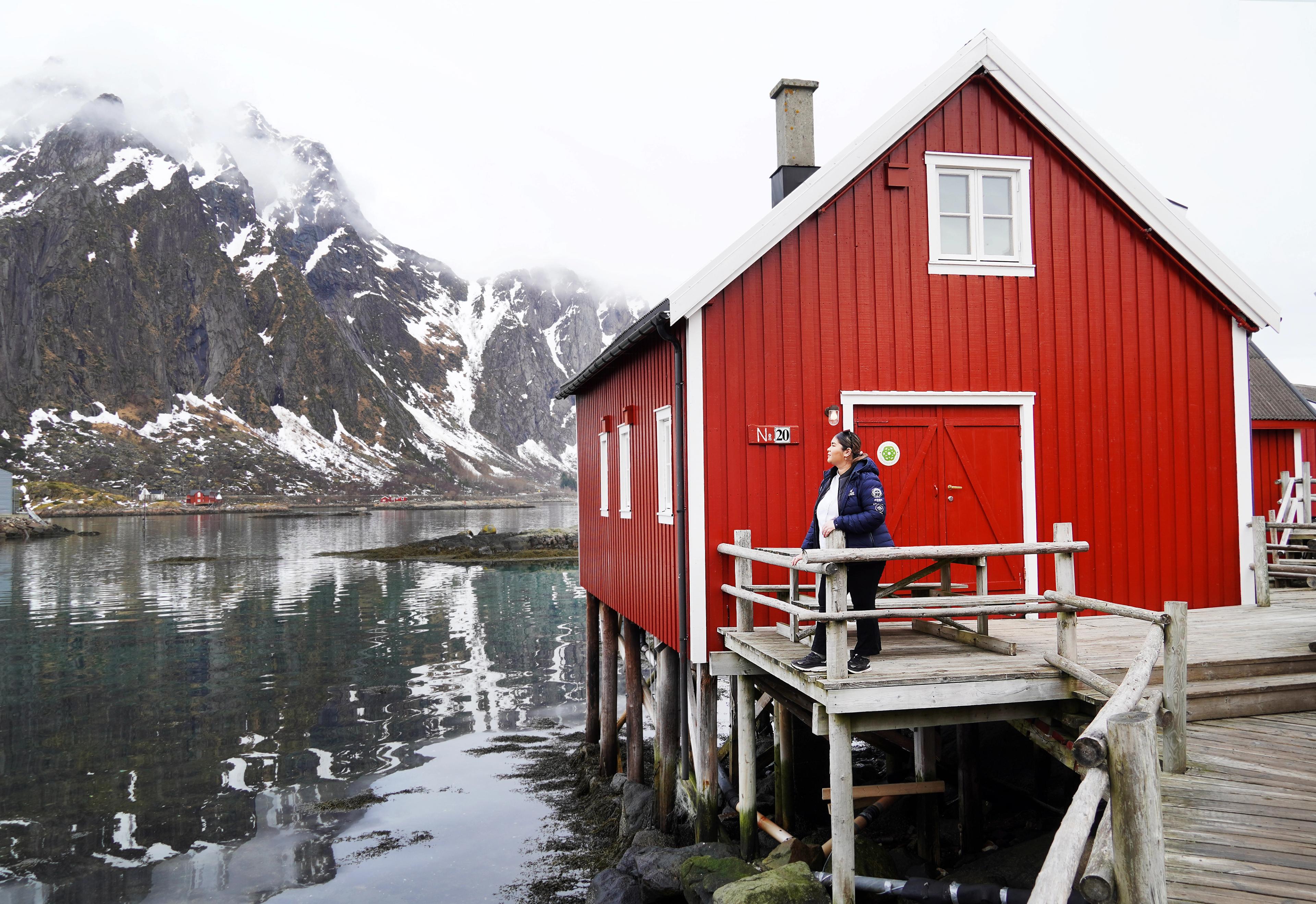 A woman in front of a fisherman´s cabin