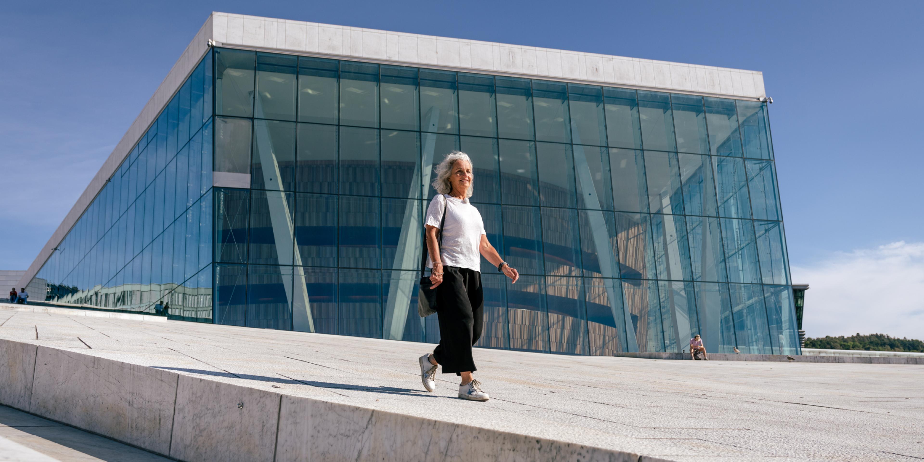 Woman walking in front of the opera house in Oslo, Eastern Norway