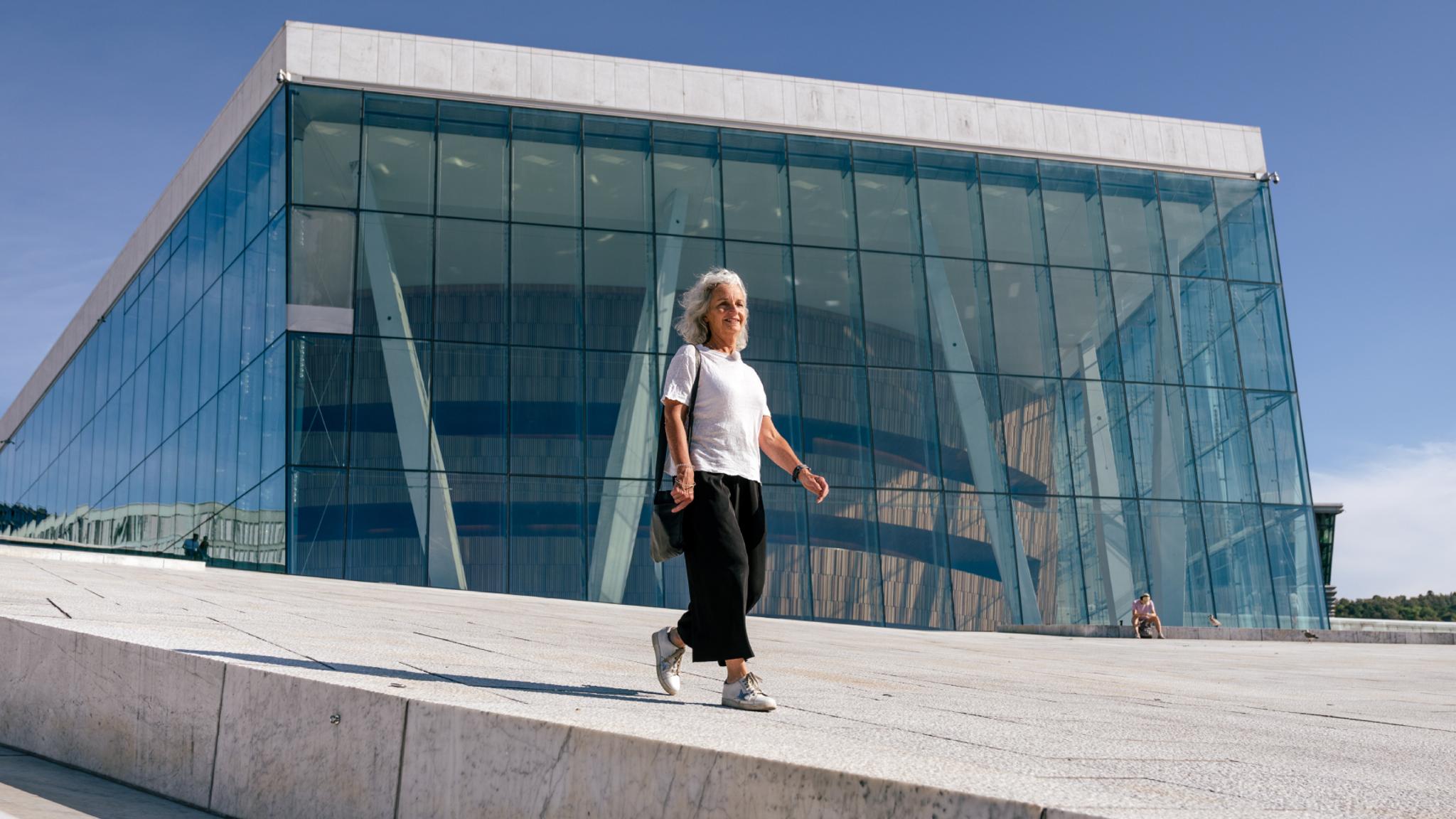 Woman walking in front of the opera house in Oslo, Eastern Norway