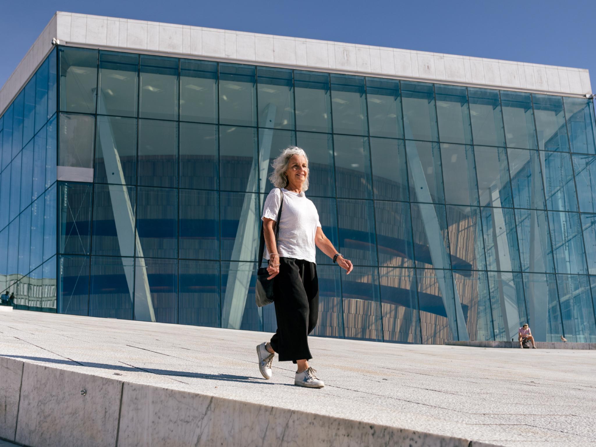 Woman walking in front of the opera house in Oslo, Eastern Norway