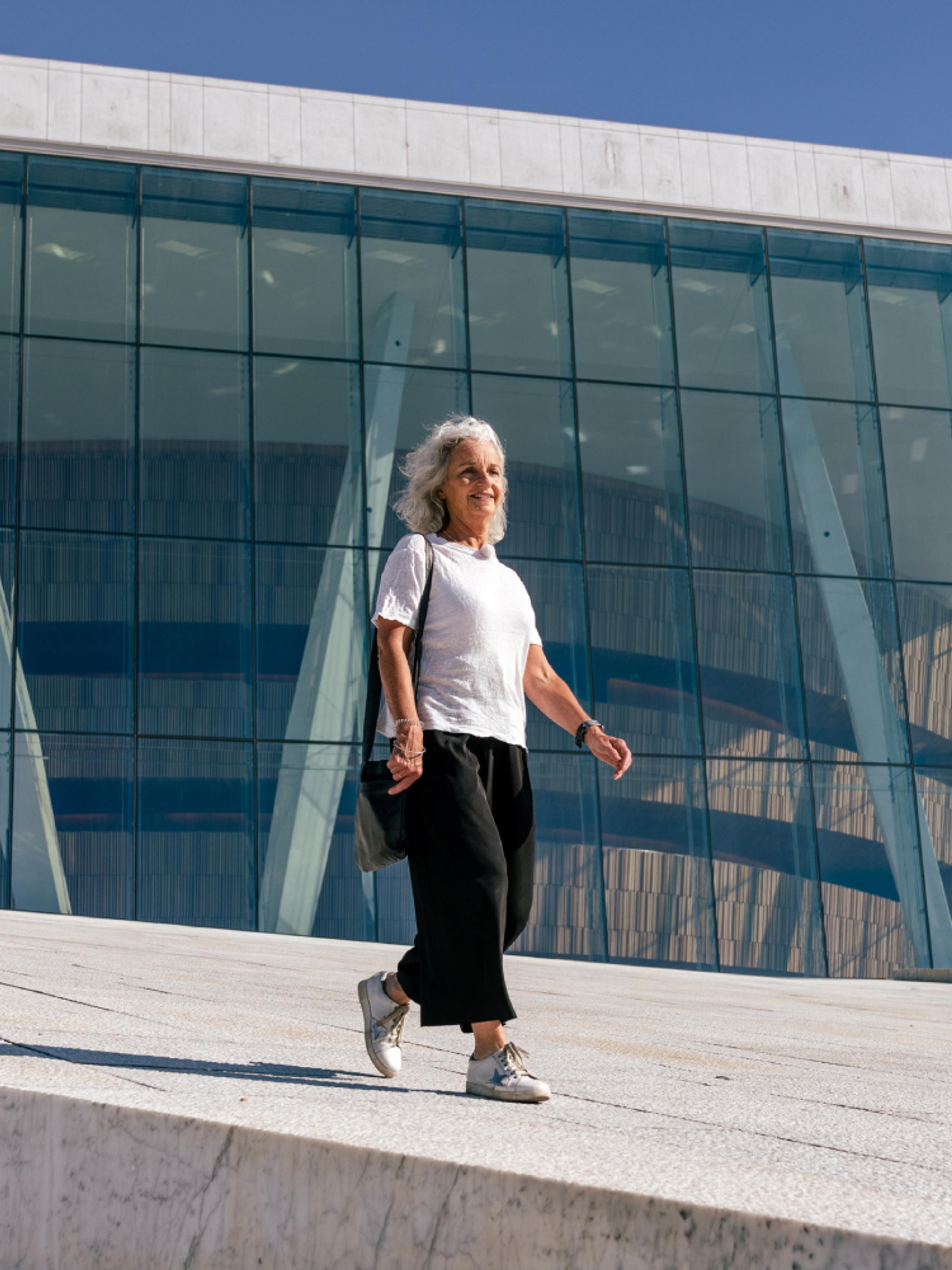 Woman walking in front of the opera house in Oslo, Eastern Norway