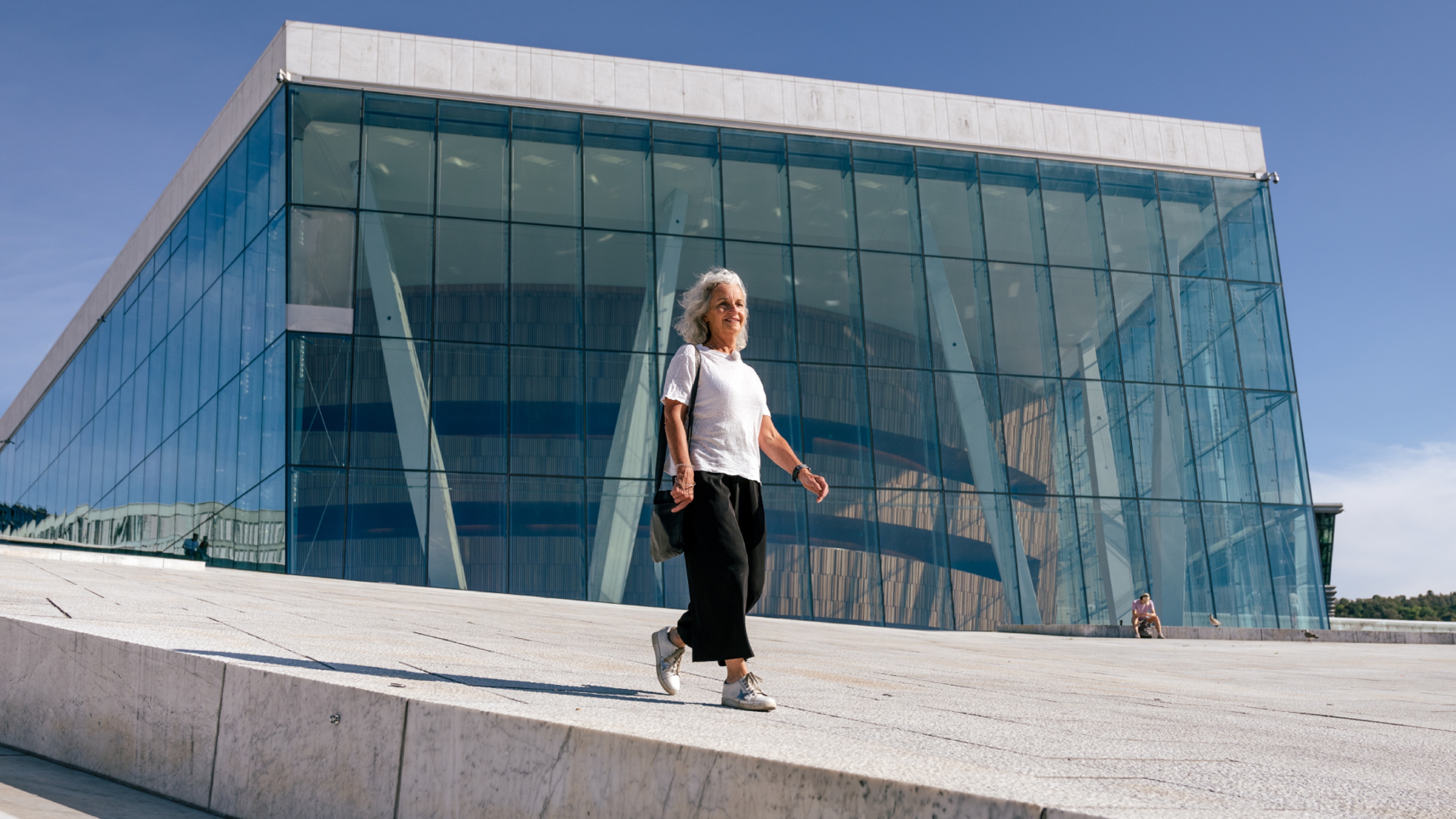 Woman walking in front of the opera house in Oslo, Eastern Norway