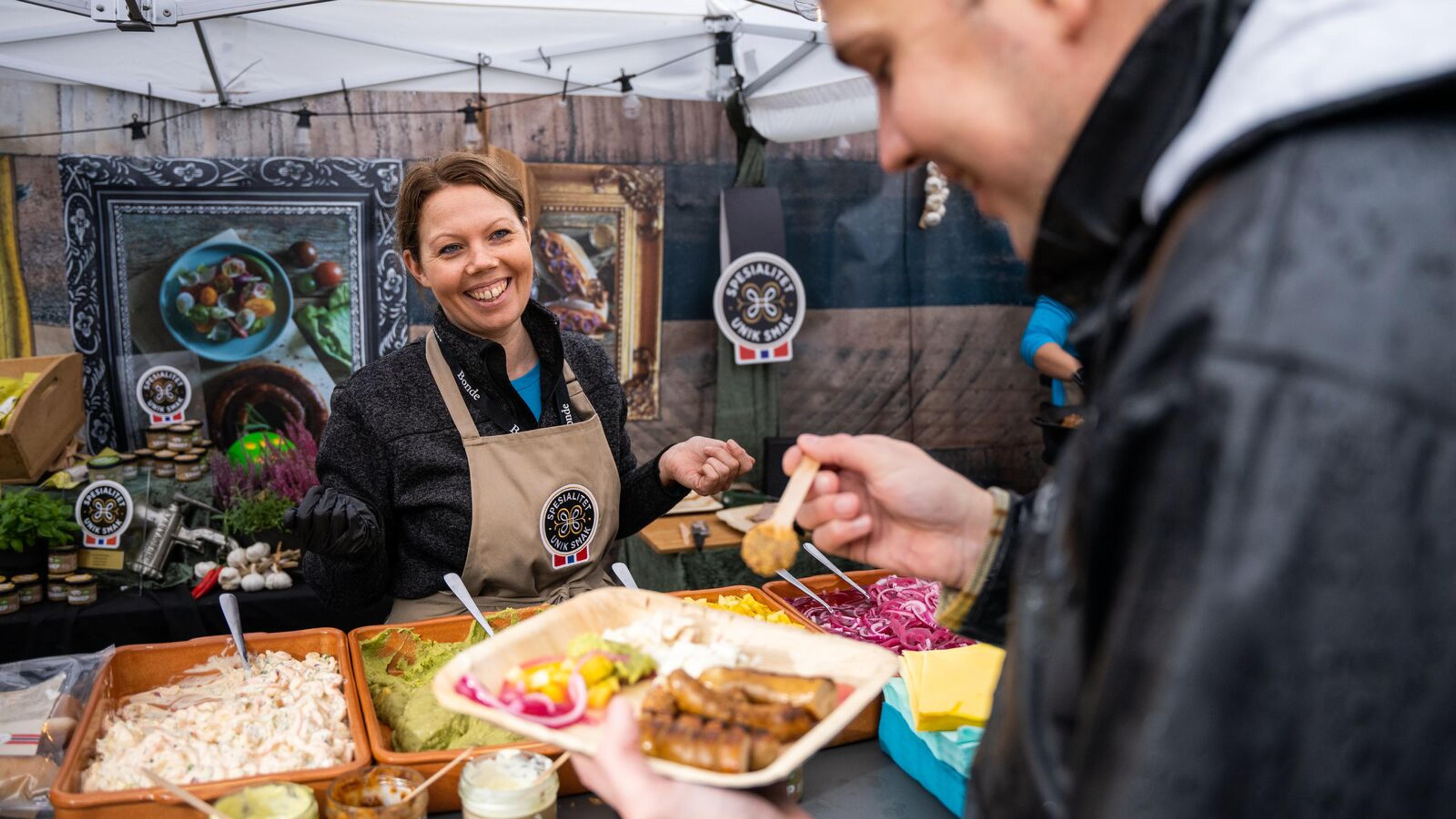 A man eating a serving of sausages at the Matstreif food festival in Oslo
