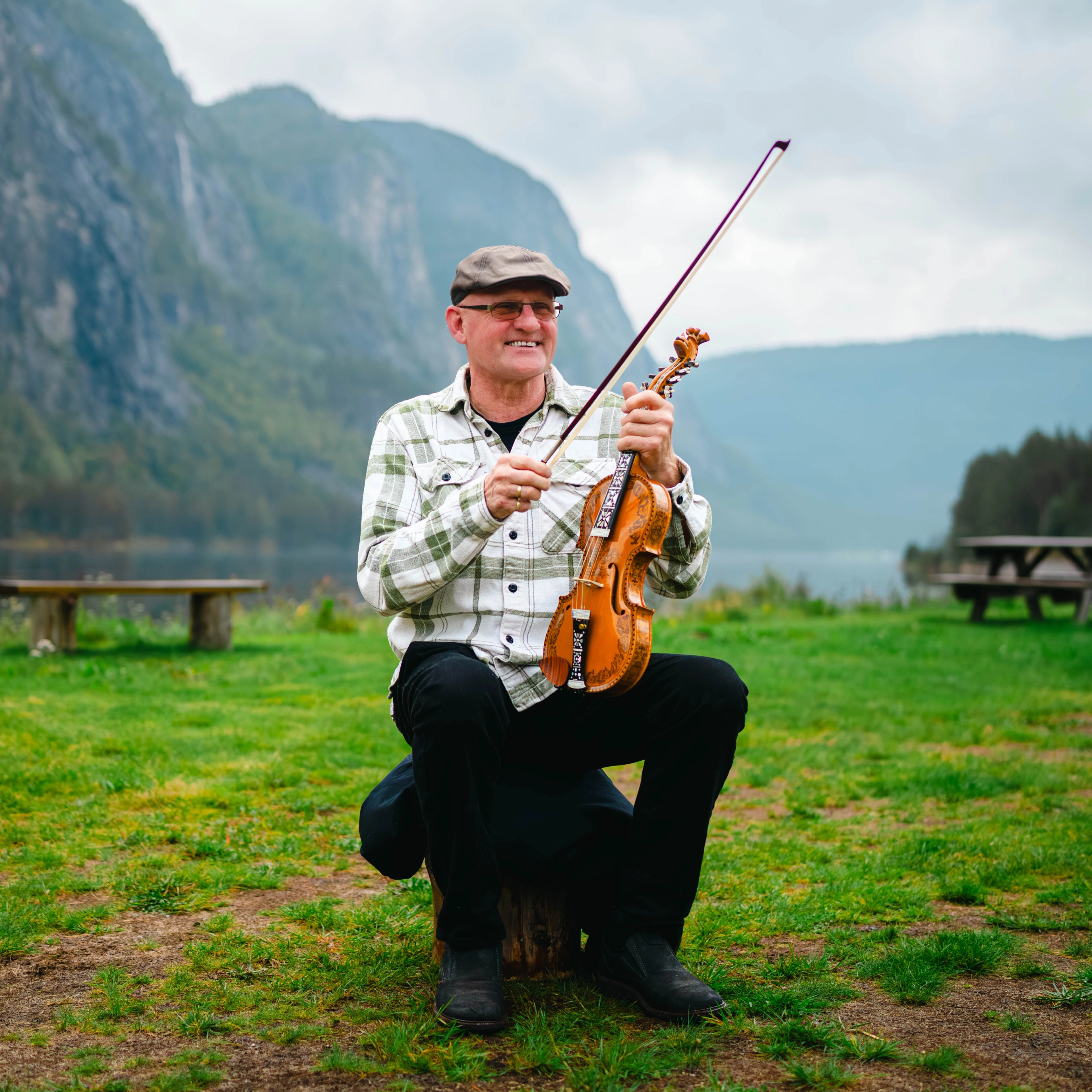 Marton Laksesvela with his Hardingfele (a unique Norwegian fiddle) with a stunning mountain backdrop in Setesdal