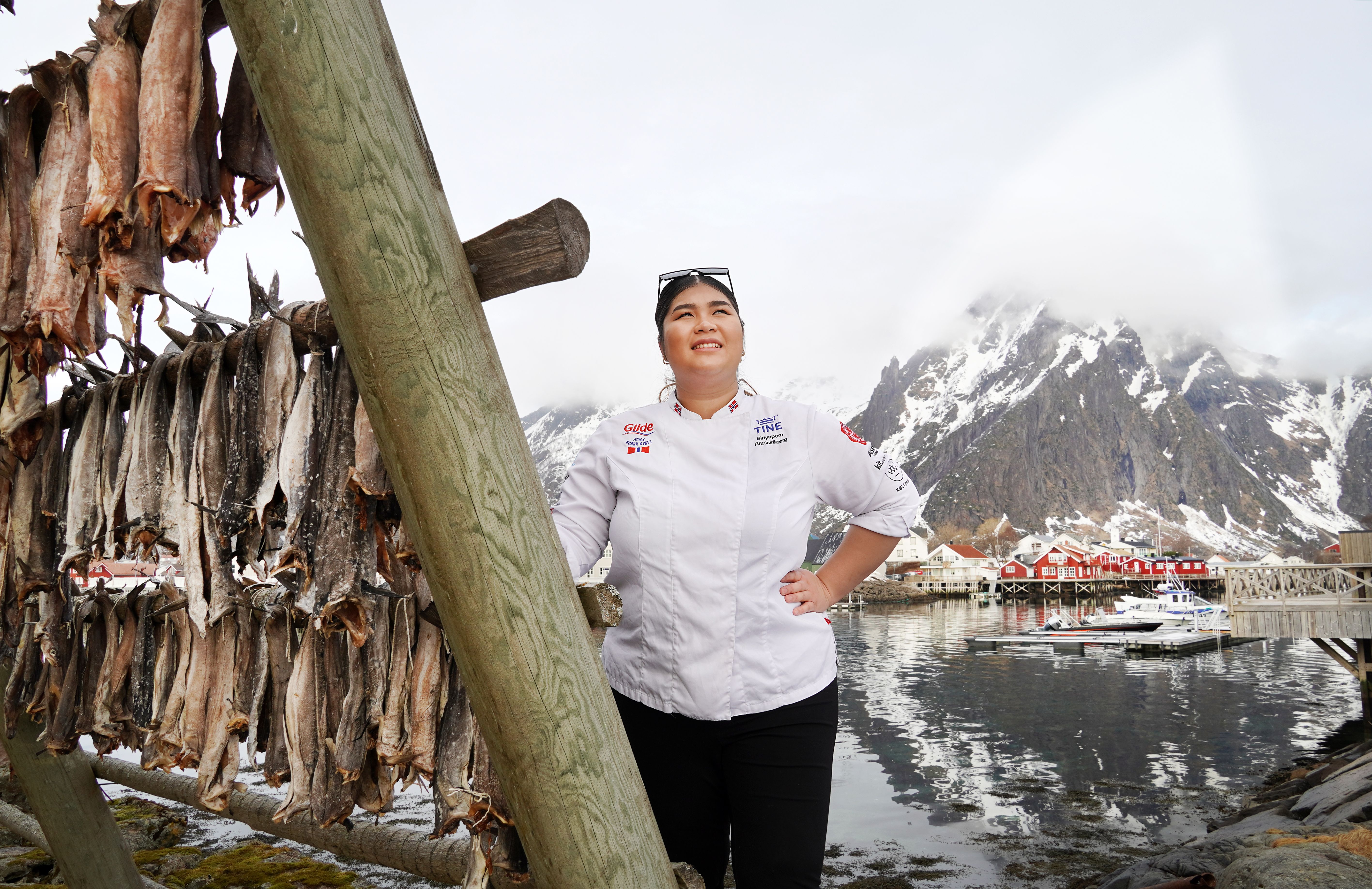 A women by stockfish on racks.