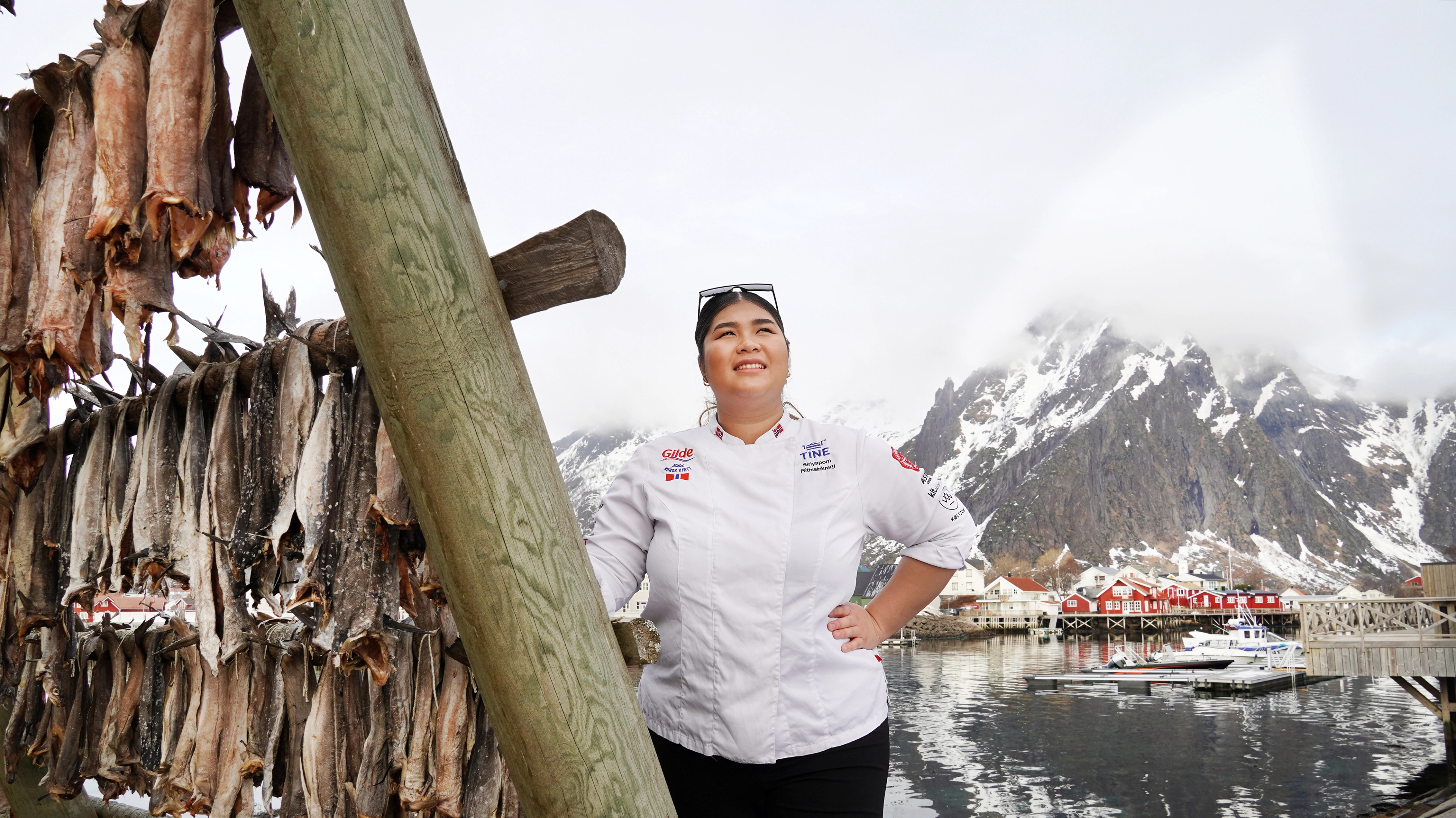 A women by stockfish on racks.