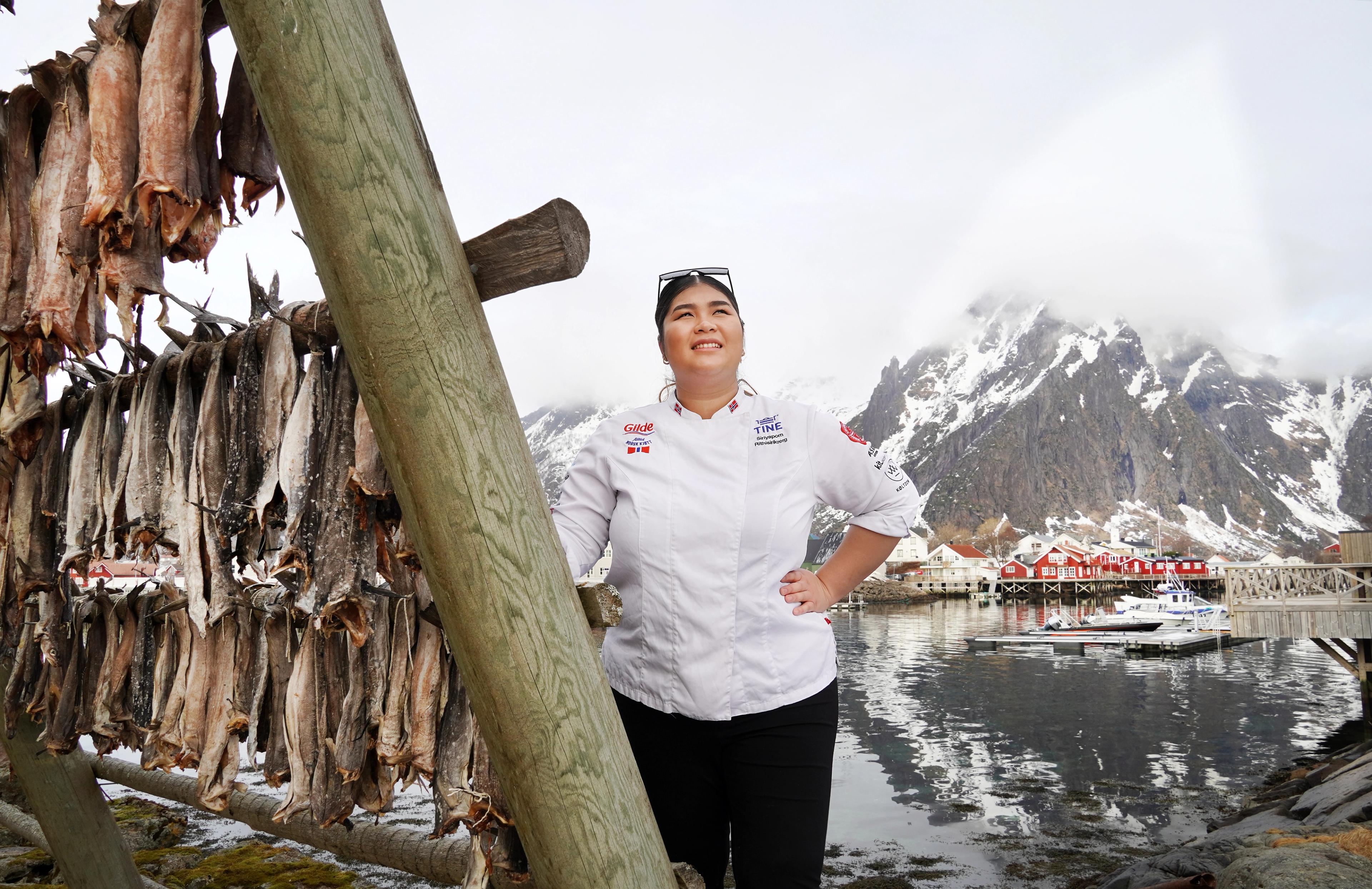 A women by stockfish on racks.