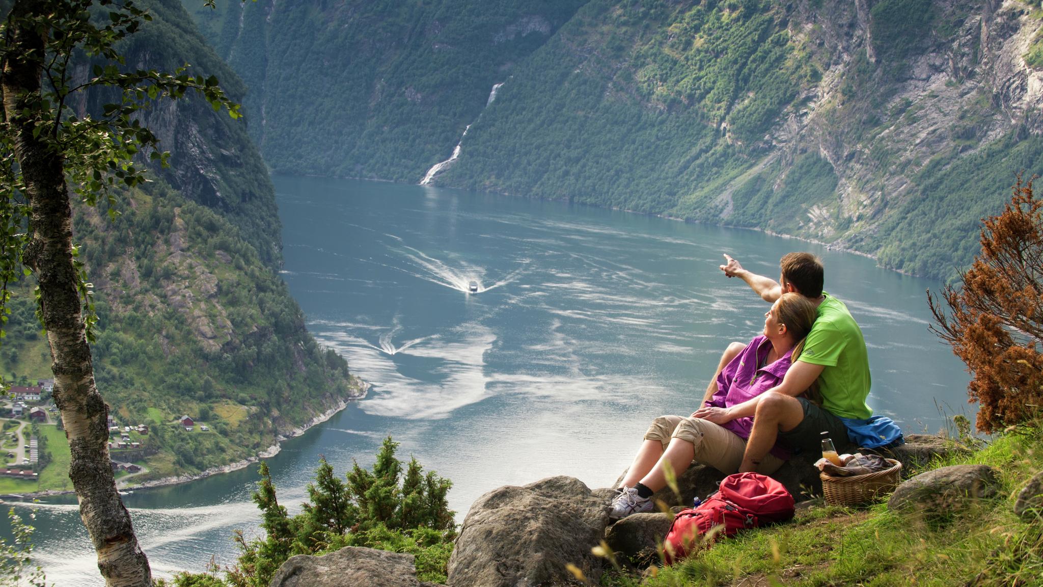 A couple having a picnic with a view in Geiranger, Fjord Norway