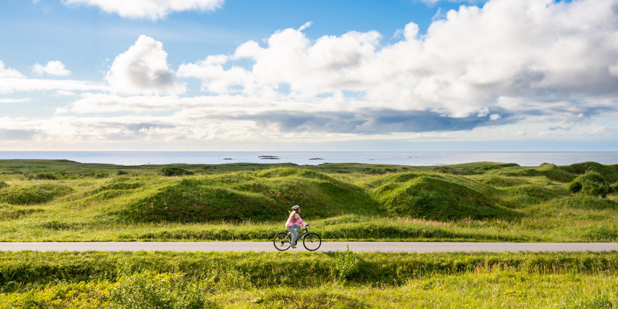 Woman biking the Norwegian Scenic Route at Andøya
