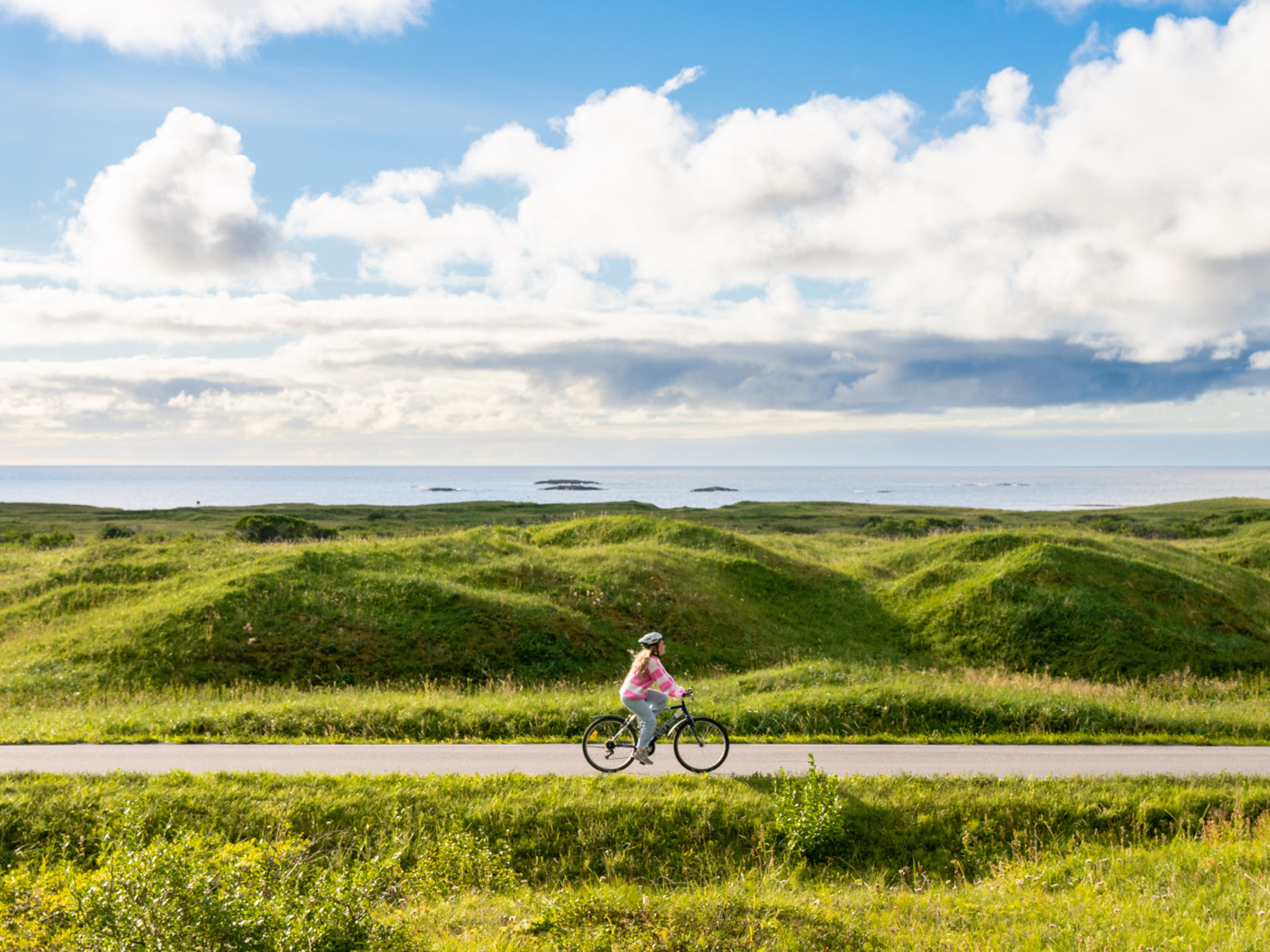 Woman biking the Norwegian Scenic Route at Andøya