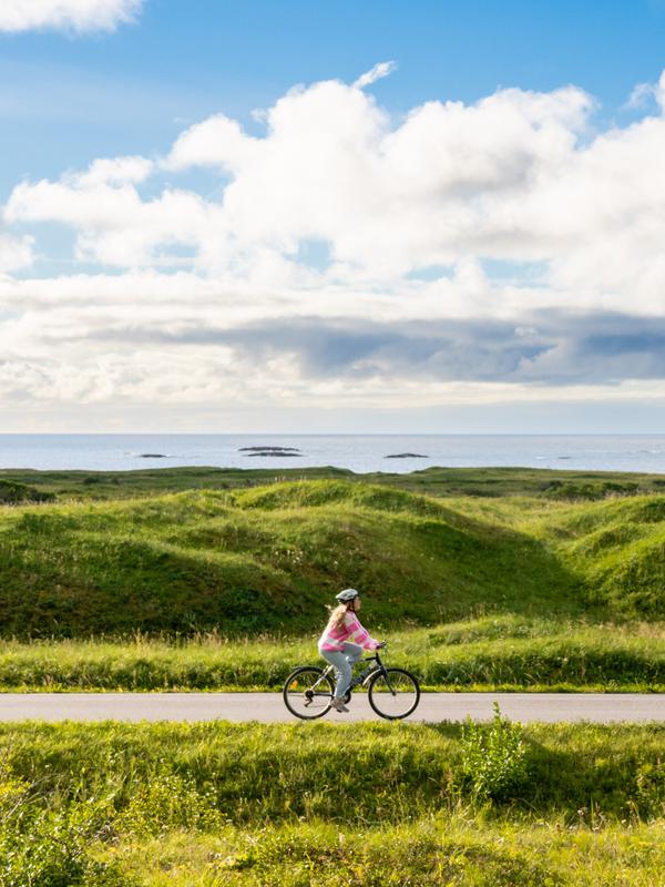 Woman biking the Norwegian Scenic Route at Andøya