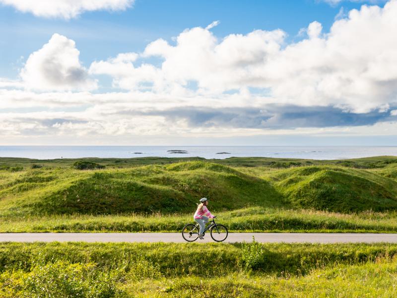Woman biking the Norwegian Scenic Route at Andøya